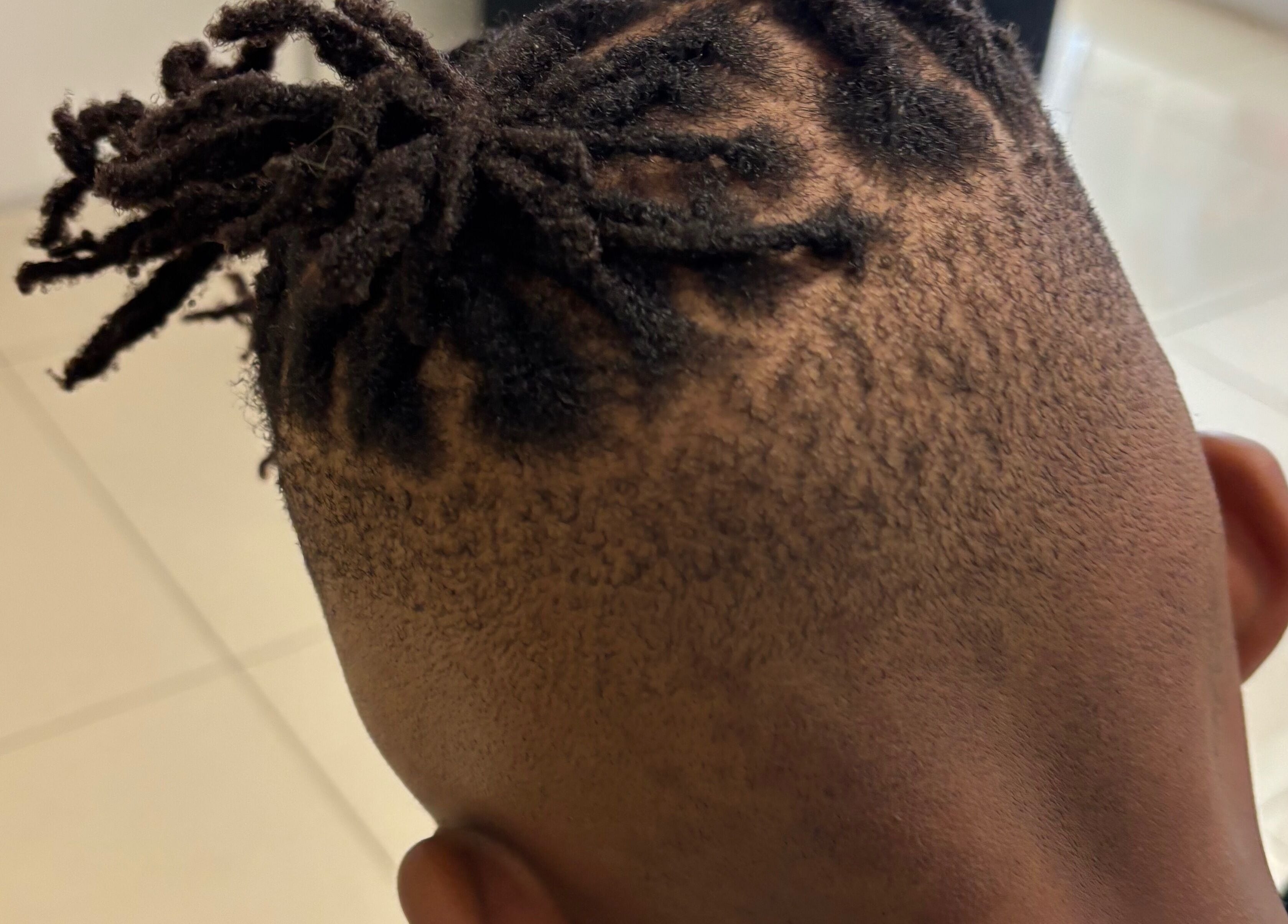 Close-up of a stylish dreadlock fade hairstyle at Lotus Beauty Hair, Cape Town, Western Cape, ZA.