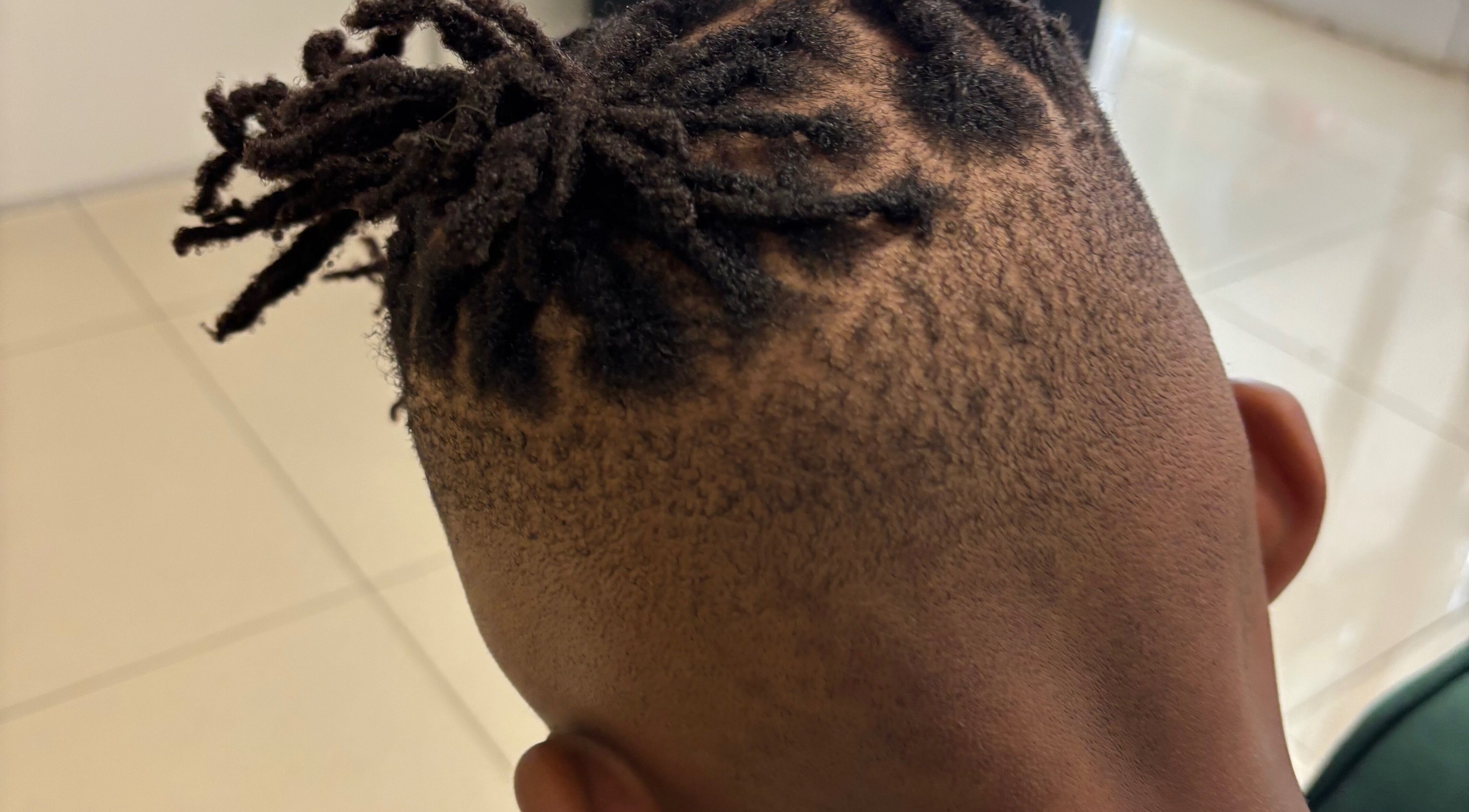 Close-up of a stylish dreadlock fade hairstyle at Lotus Beauty Hair, Cape Town, Western Cape, ZA.