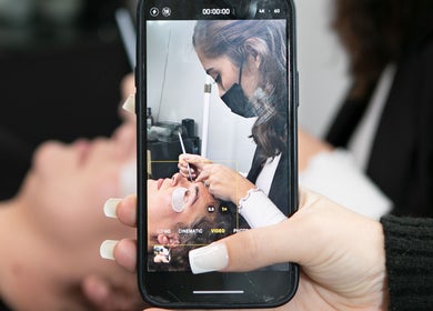 A specialist applying eyelash extensions at The Brash Collective, Marlow, England, GB.