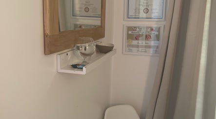 Cozy corner at Eva B. Wiebe, CMP in Aylmer, ON, CA, adorned with certificates and a mirror above a shelf.