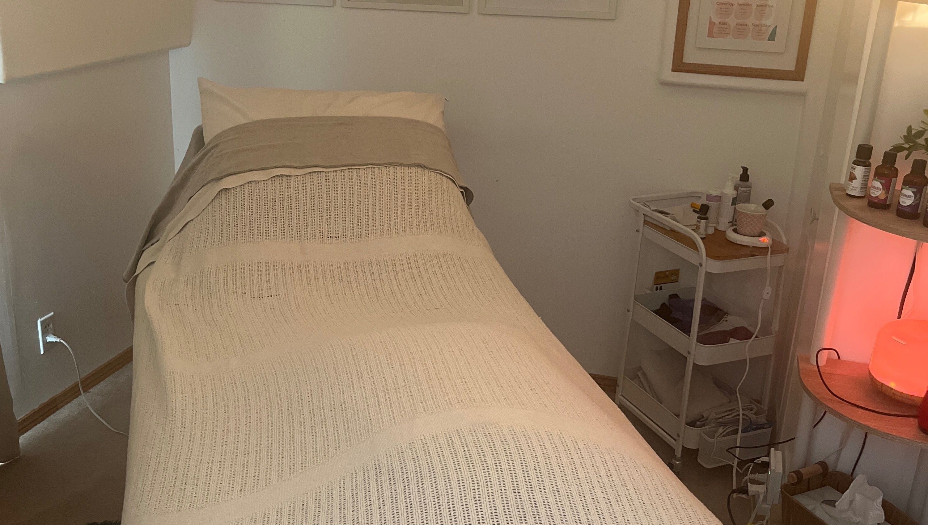 Calm treatment room at Eva B. Wiebe, CMP, Aylmer, ON, CA with a bed and wellness products.