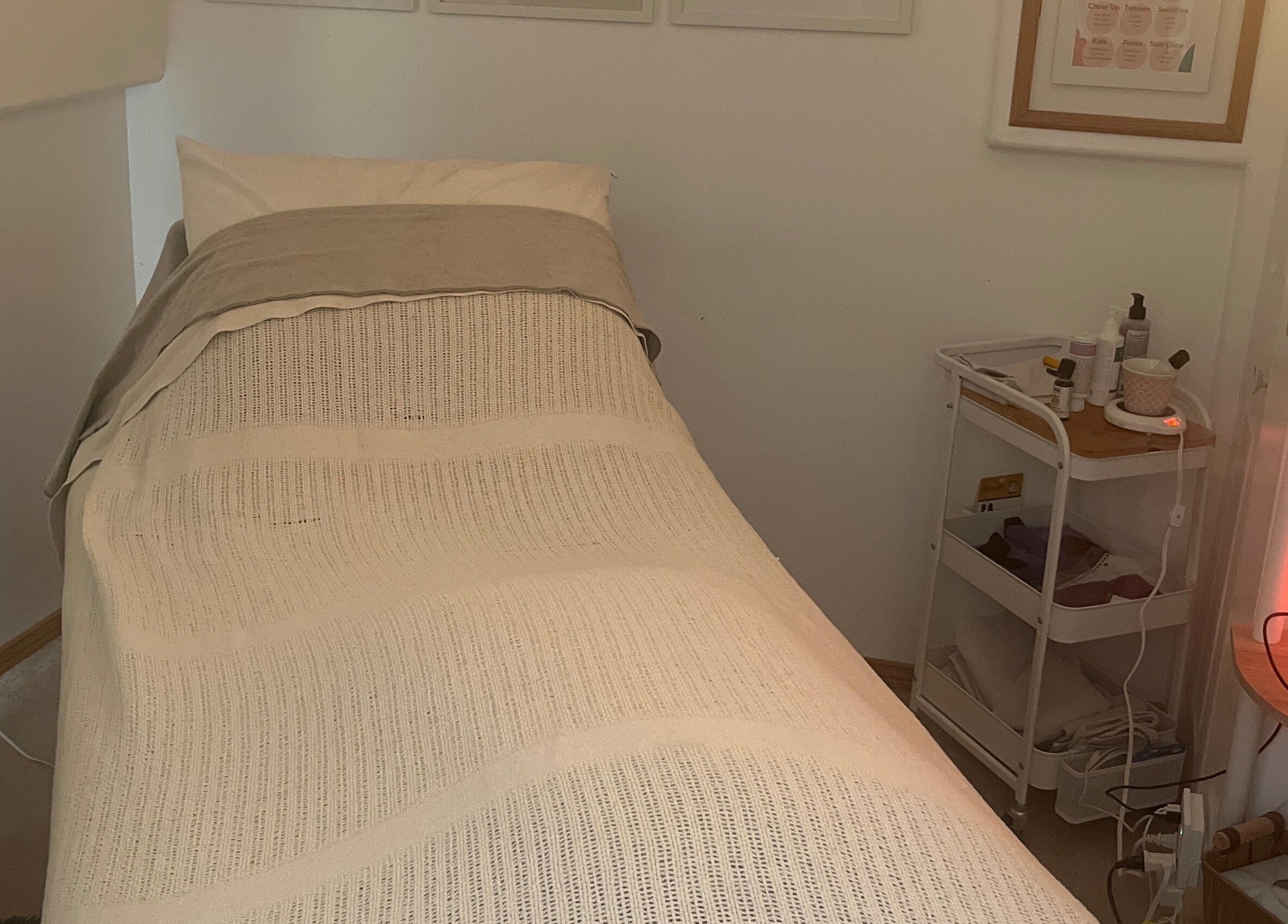 Calm treatment room at Eva B. Wiebe, CMP, Aylmer, ON, CA with a bed and wellness products.