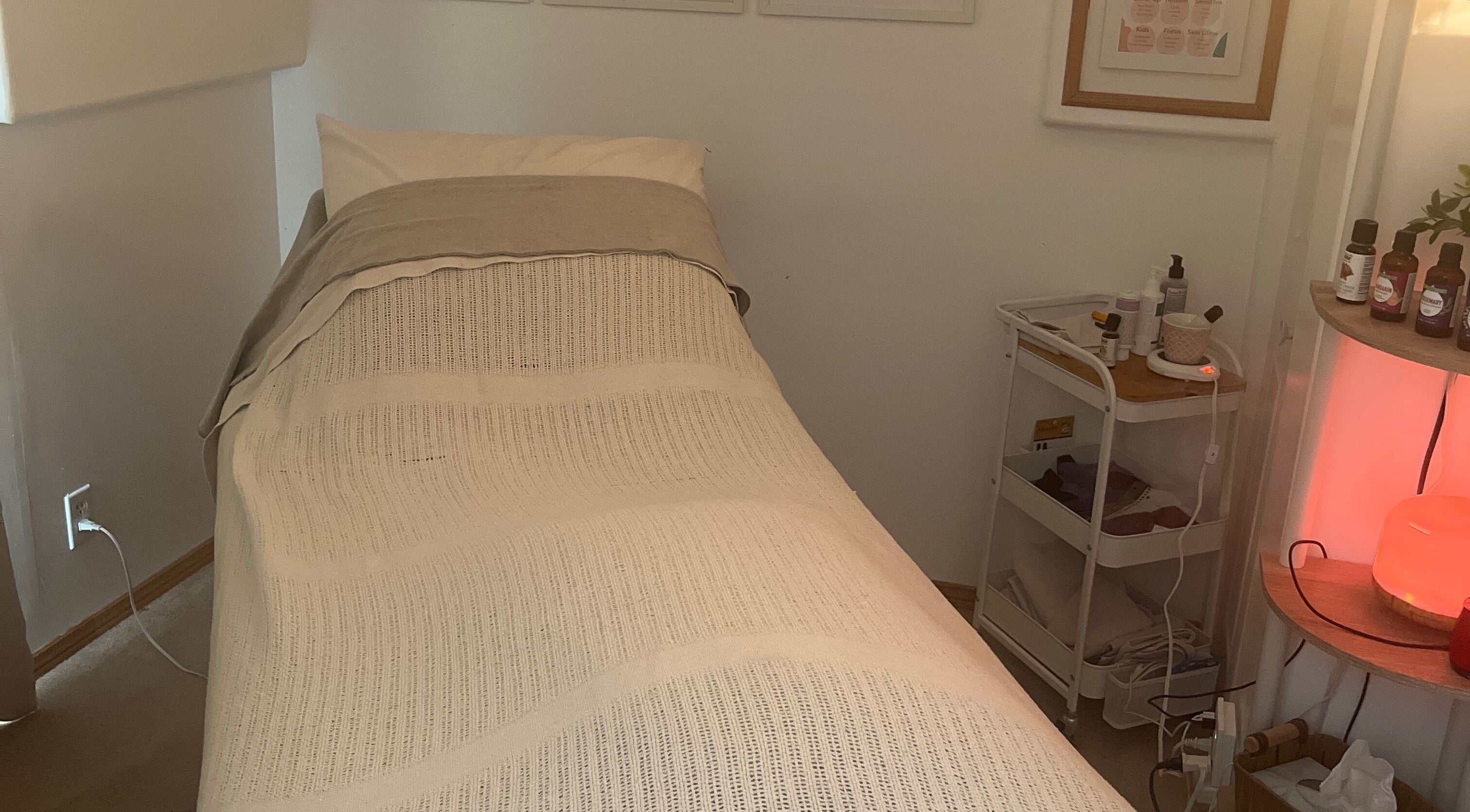 Calm treatment room at Eva B. Wiebe, CMP, Aylmer, ON, CA with a bed and wellness products.