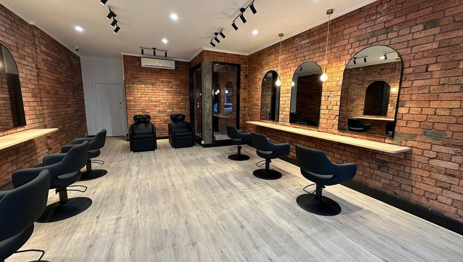 Chic interior of Hair by Coco Milk salon in Melbourne, Victoria, AU with modern styling chairs and mirrors.