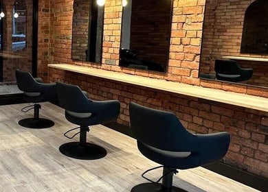 Modern salon interior at Hair by Coco Milk, Melbourne, Victoria, AU with sleek styling chairs and mirrors.