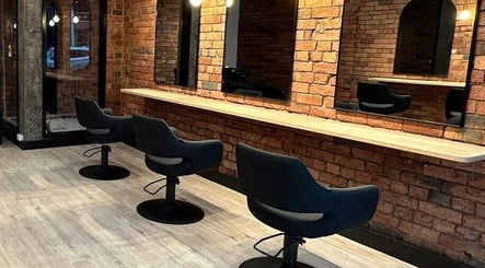 Modern salon interior at Hair by Coco Milk, Melbourne, Victoria, AU with sleek styling chairs and mirrors.