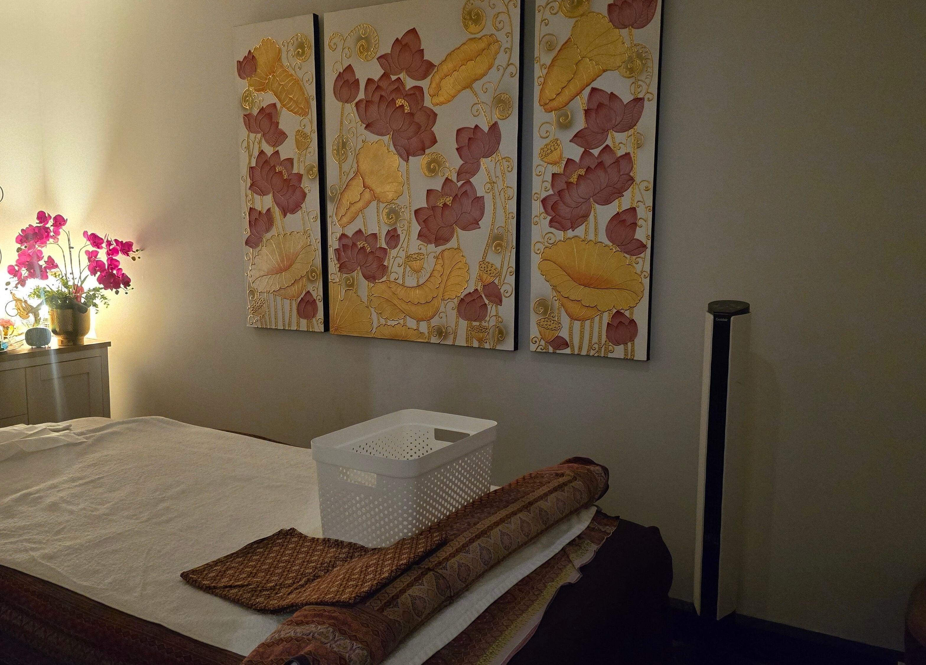 Relaxing massage room with floral art and ambient lighting at Royal Paradise Thai Massage and Remedial, Milton, Queensland, AU.