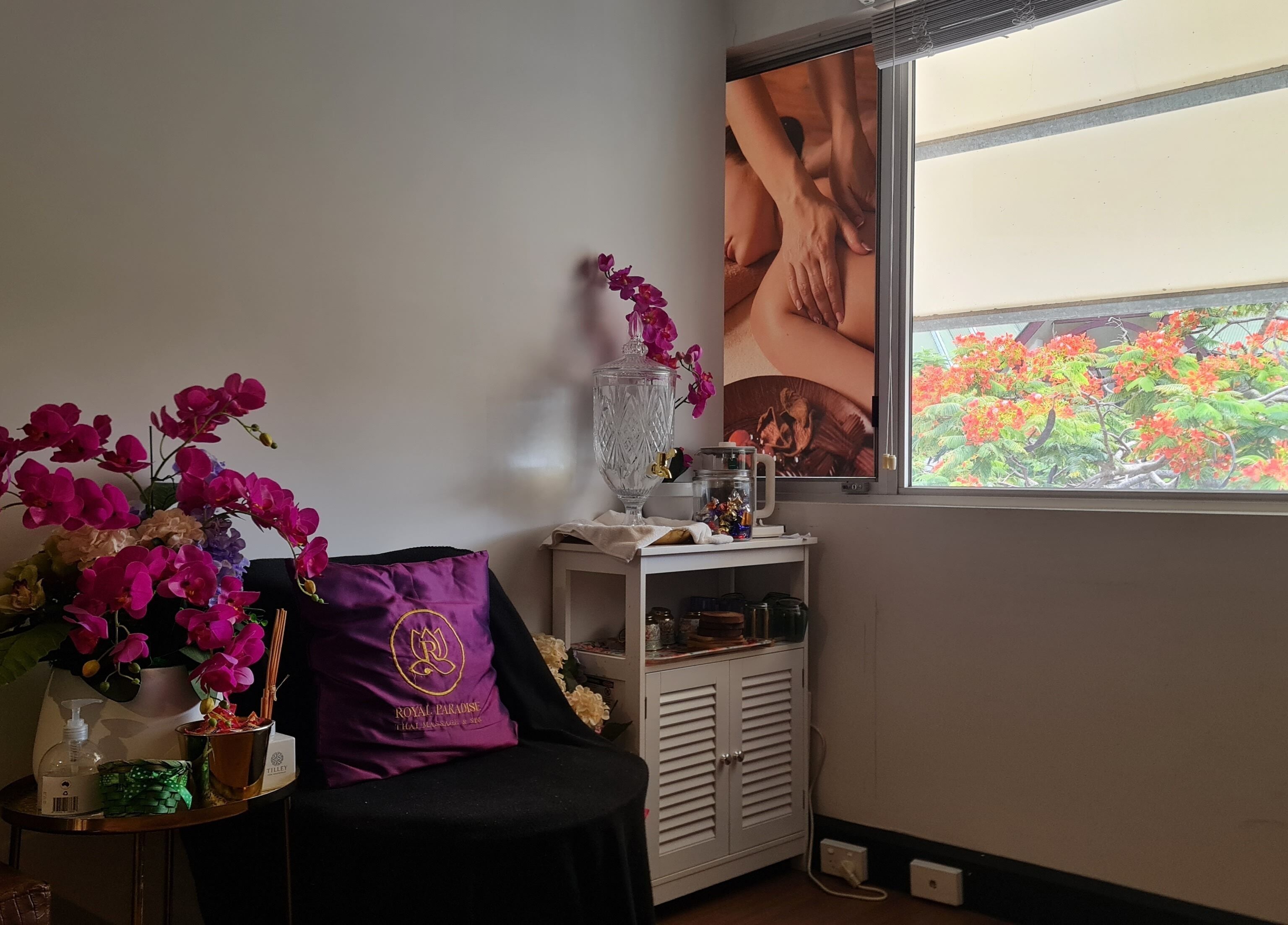 Relaxing interior of Royal Paradise Thai Massage and Remedial, Milton, Queensland, AU, with vibrant flowers.