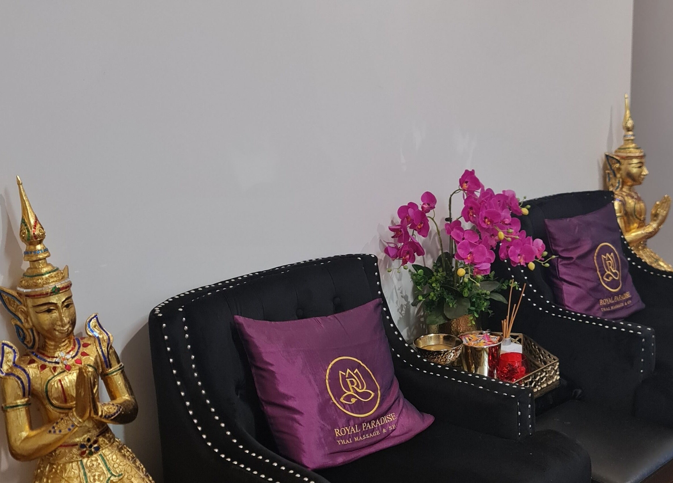 Cozy seating with gold statue and orchid at Royal Paradise Thai Massage and Remedial, Milton, Queensland, AU.