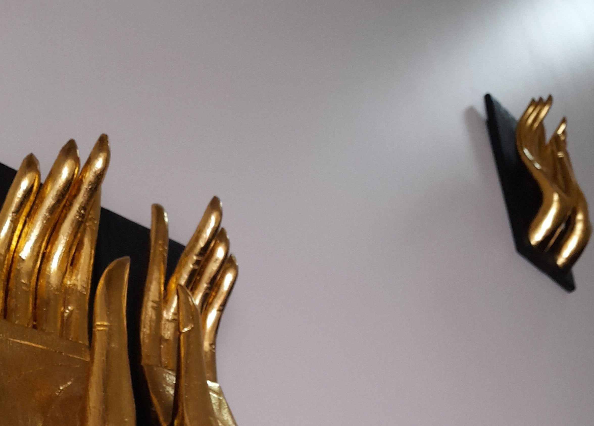 Golden hands decor at Royal Paradise Thai Massage and Remedial in Milton, Queensland, AU, evoking a tranquil ambience.