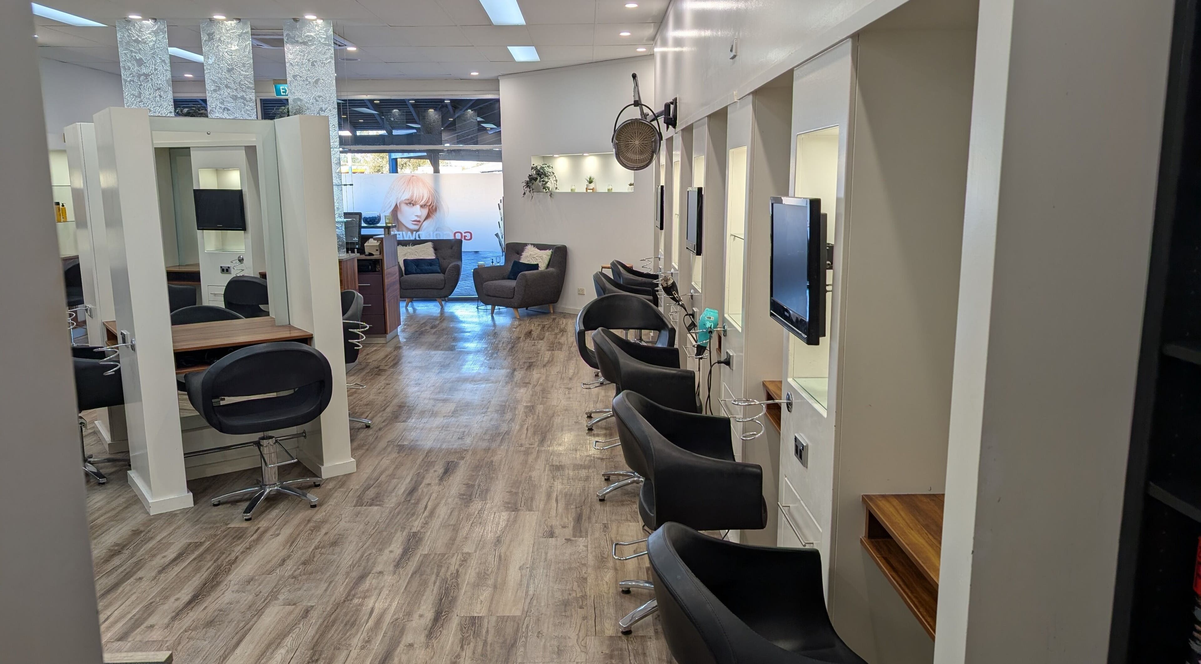 Elegant interior of FIG salon in Bull Creek, Western Australia, AU with sleek black chairs and modern decor.
