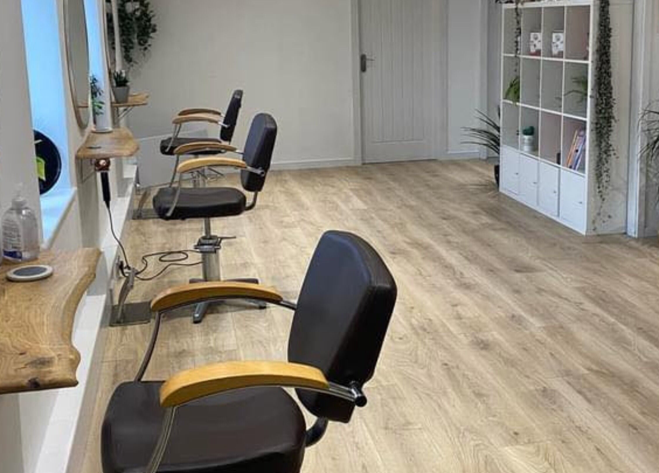 Spacious interior of 20 Twenty Hair Salon in Falmouth, England, GB featuring stylish chairs and modern decor.