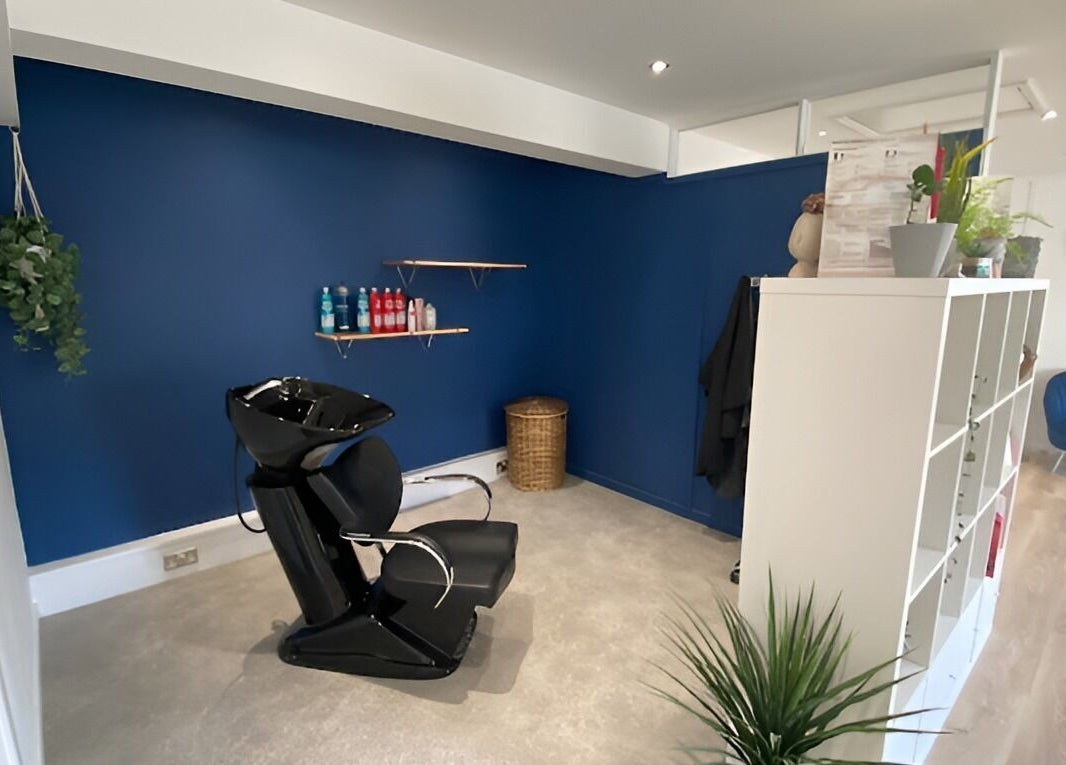 Modern hair washing station at 20 Twenty Hair Salon in Falmouth, England, GB. Sleek design with a blue wall.