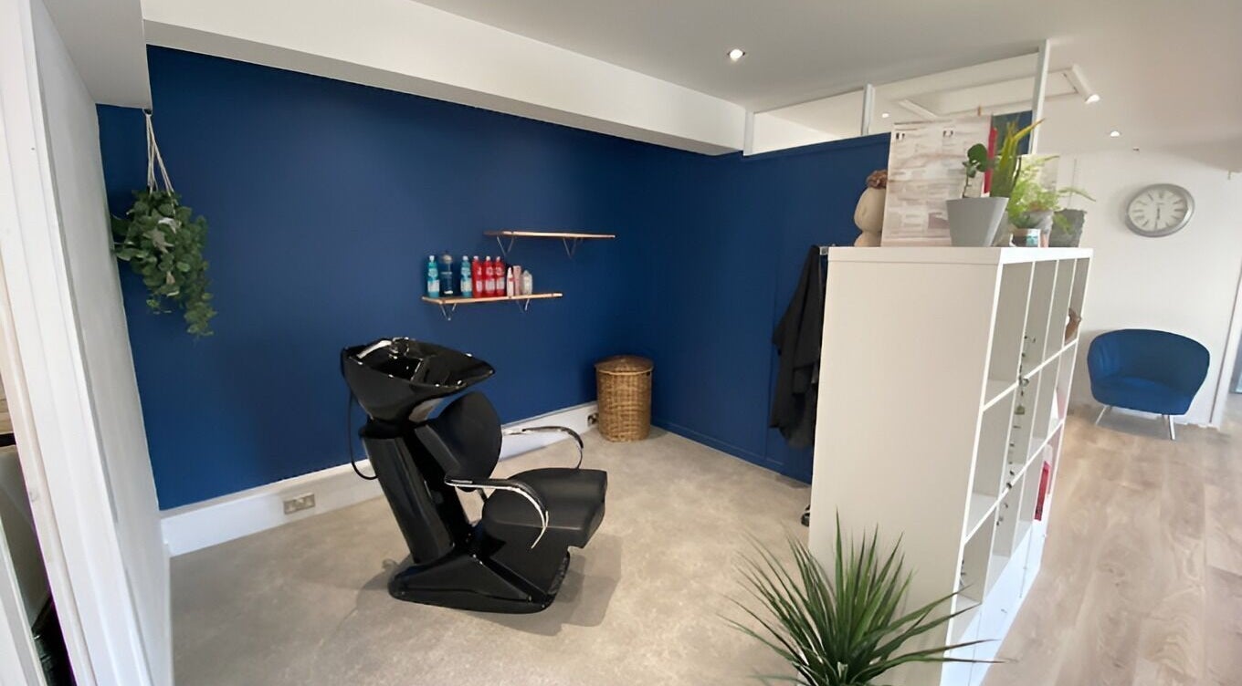 Modern hair washing station at 20 Twenty Hair Salon in Falmouth, England, GB. Sleek design with a blue wall.