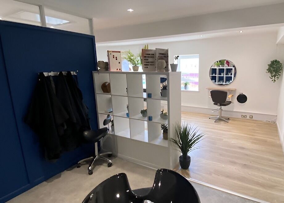 Modern interior of 20 Twenty Hair Salon in Falmouth, England, GB, featuring sleek chairs and stylish decor.