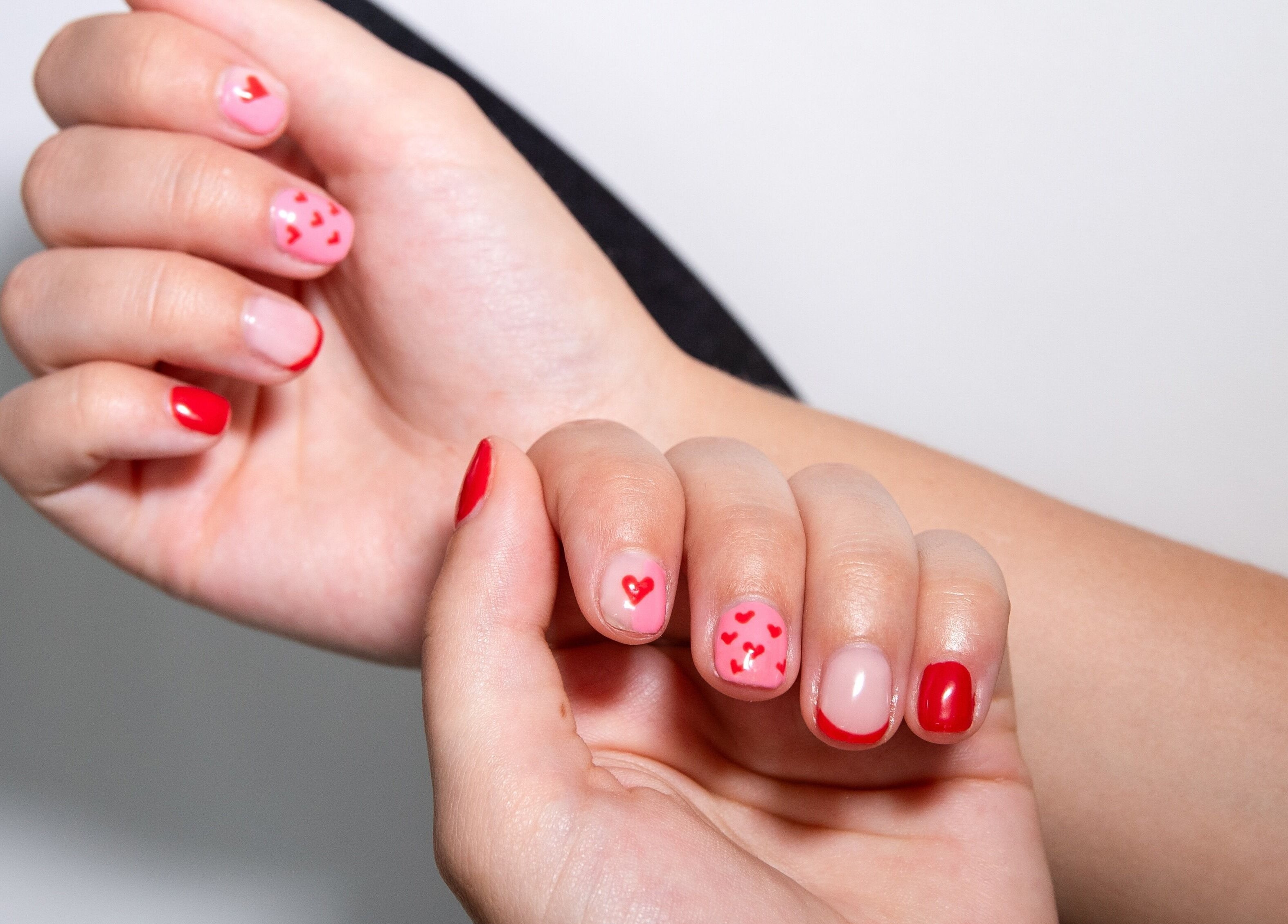 Heart-themed nail art at Nova Beauty Studio, Cape Town, Western Cape, ZA, showcasing red and pink designs.