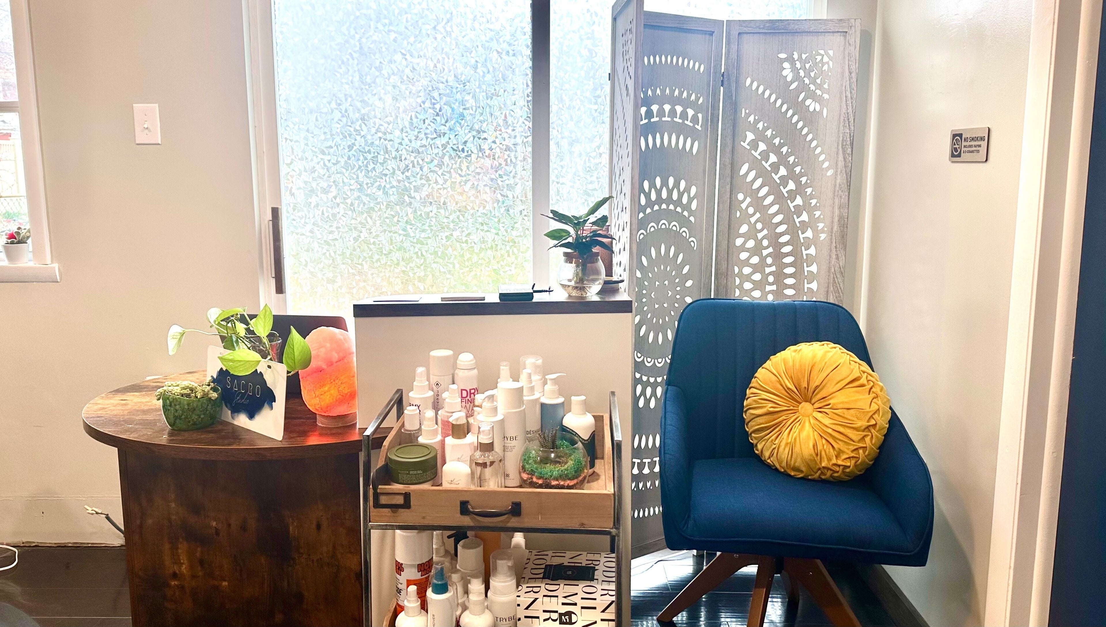 A relaxing corner at Sacro Studio, LLC in Bethlehem, Pennsylvania, US showcasing plants and beauty products.