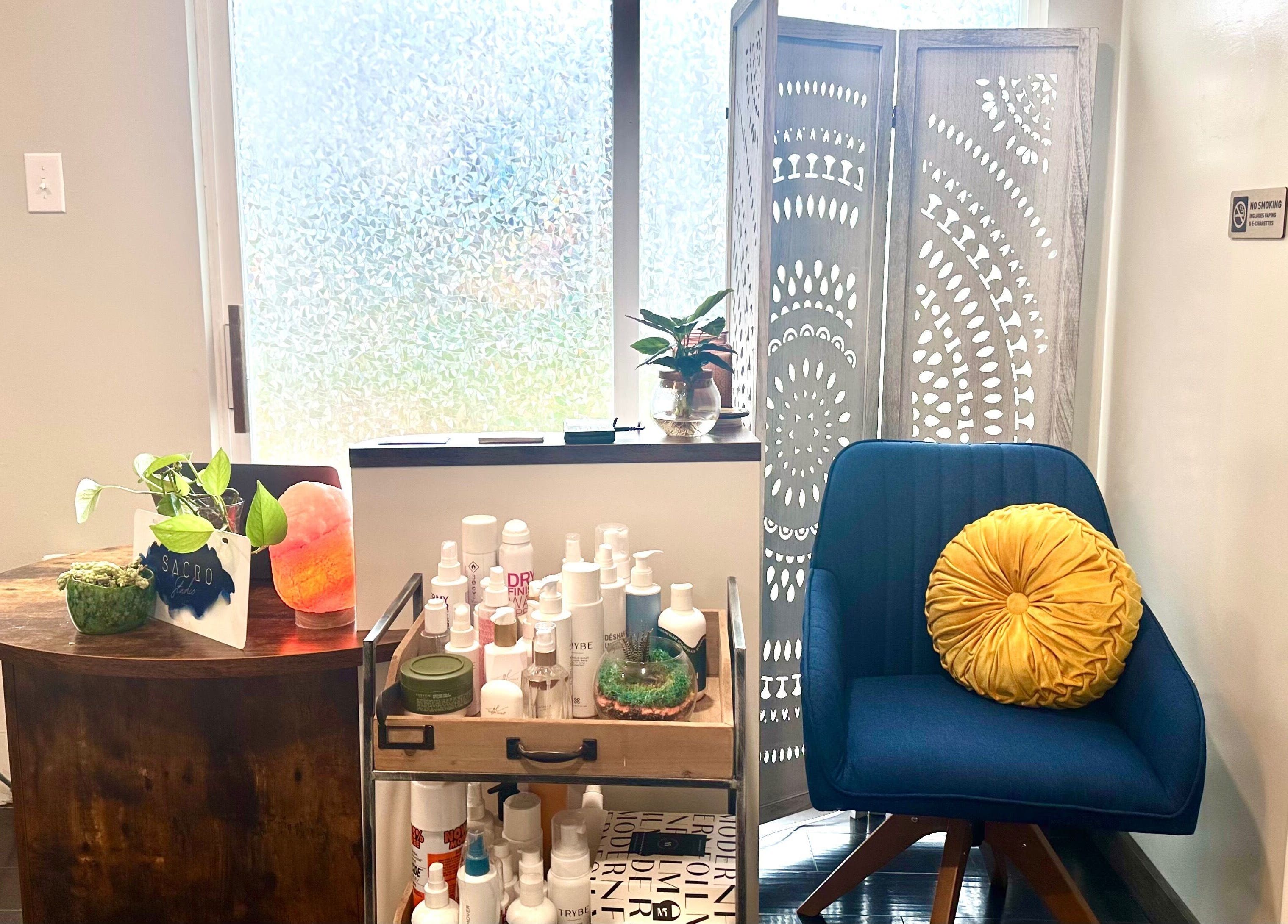 A relaxing corner at Sacro Studio, LLC in Bethlehem, Pennsylvania, US showcasing plants and beauty products.