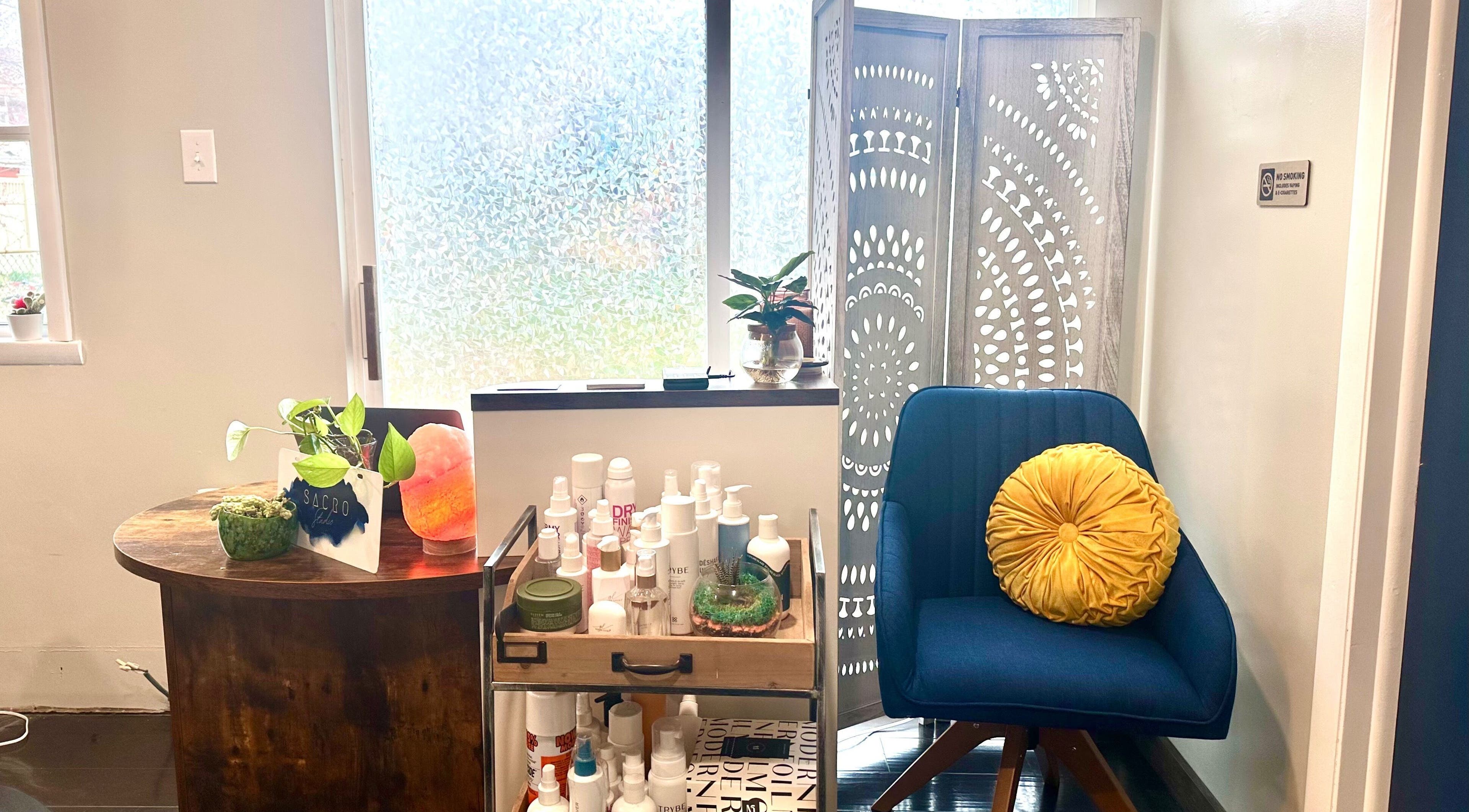 A relaxing corner at Sacro Studio, LLC in Bethlehem, Pennsylvania, US showcasing plants and beauty products.