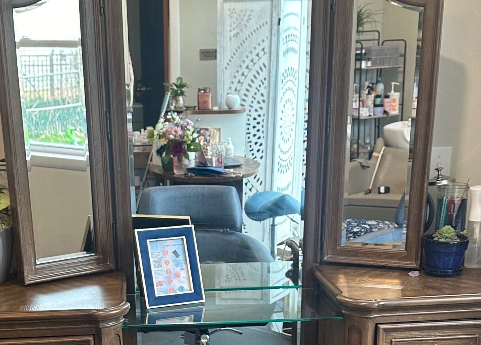 Elegant vanity setup at Sacro Studio, LLC, Bethlehem, Pennsylvania, US, with mirrors and floral decor.