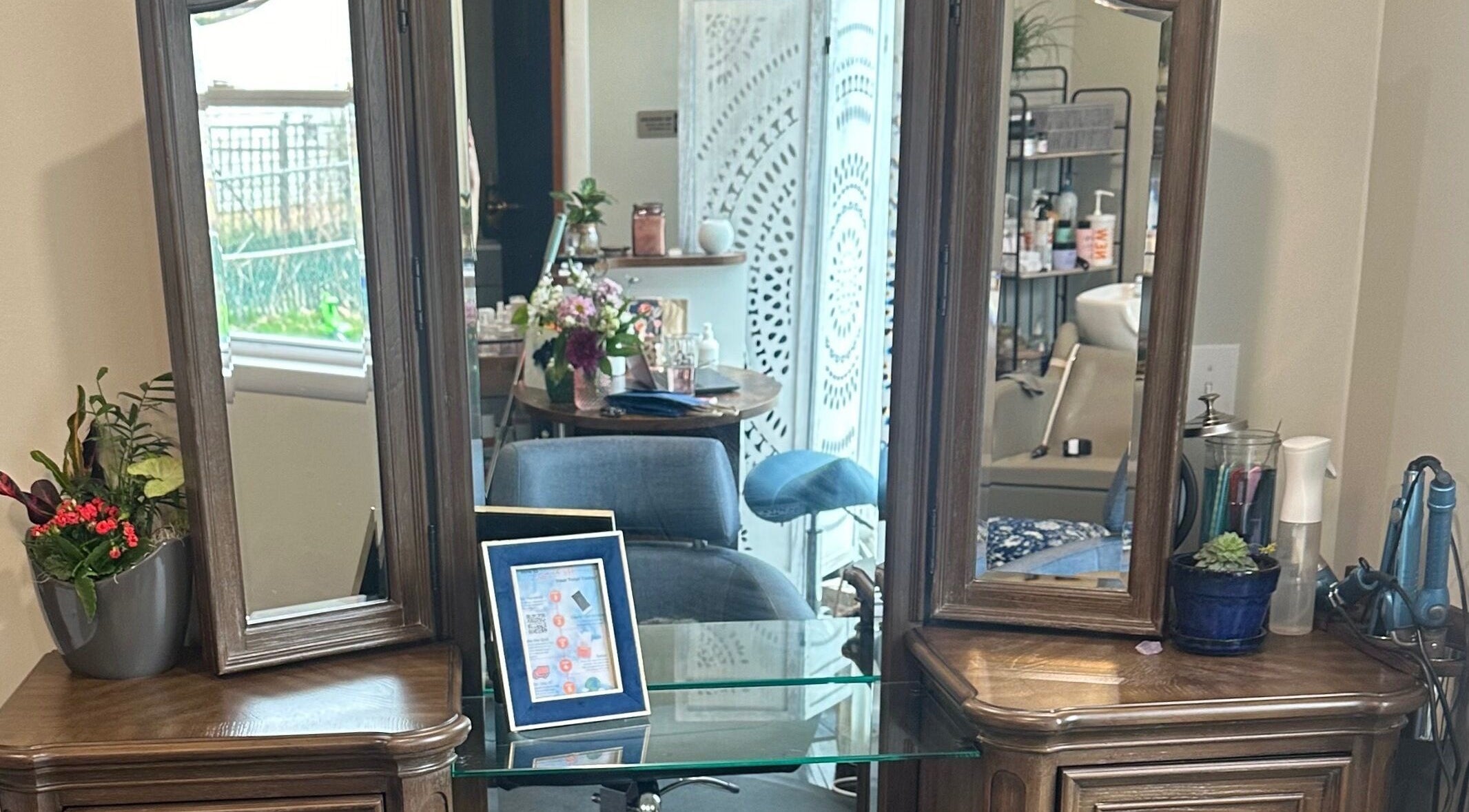 Elegant vanity setup at Sacro Studio, LLC, Bethlehem, Pennsylvania, US, with mirrors and floral decor.