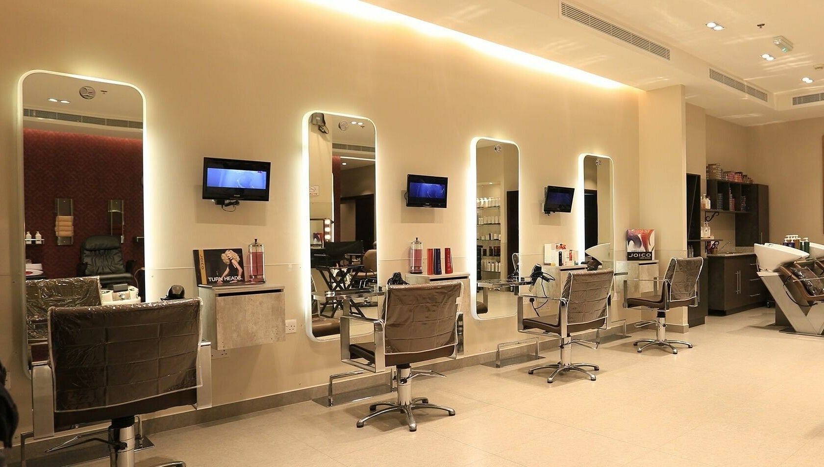 Modern interior of Amaya Salon and Spa in Dubai, AE showcasing elegant styling chairs and mirrored stations.