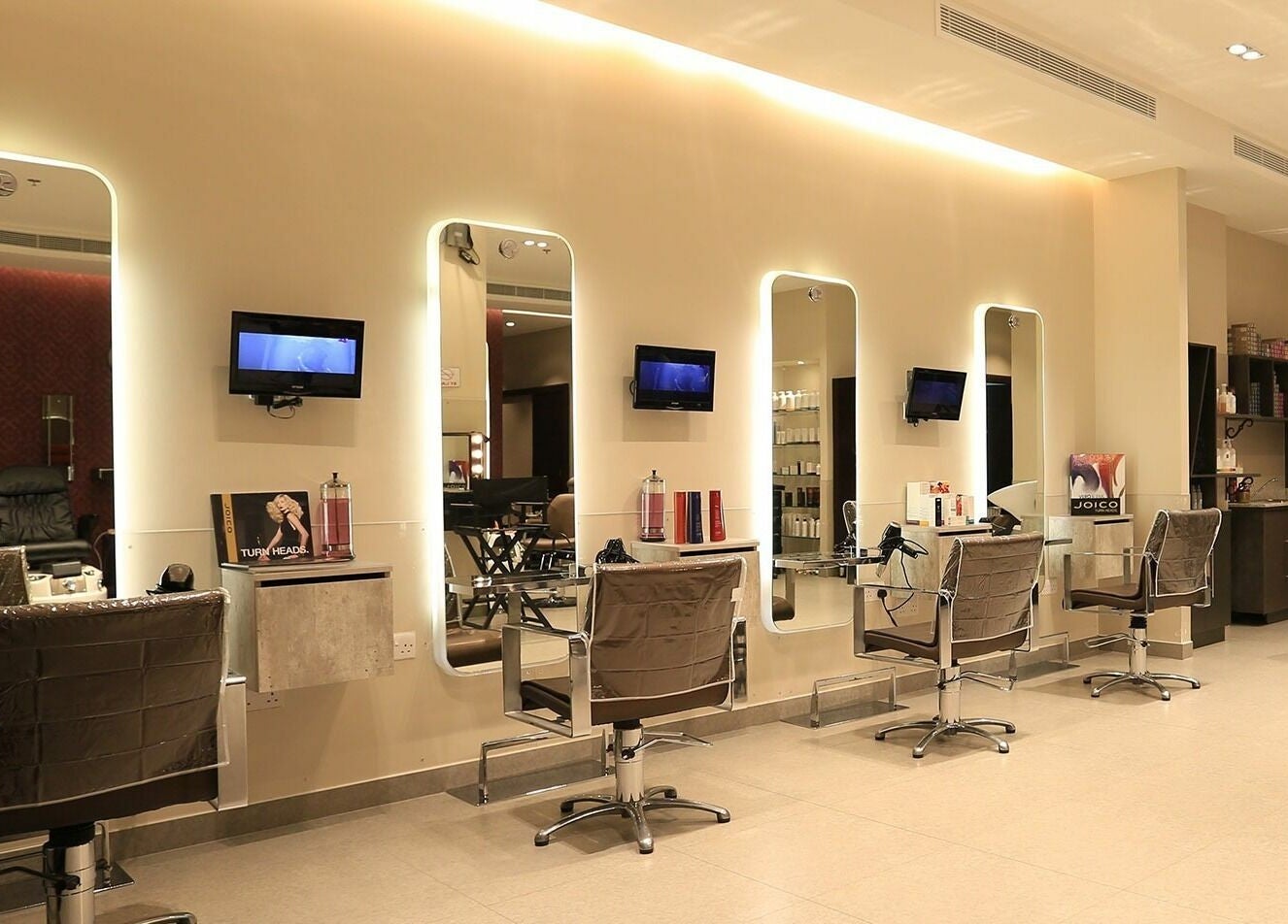 Modern interior of Amaya Salon and Spa in Dubai, AE showcasing elegant styling chairs and mirrored stations.