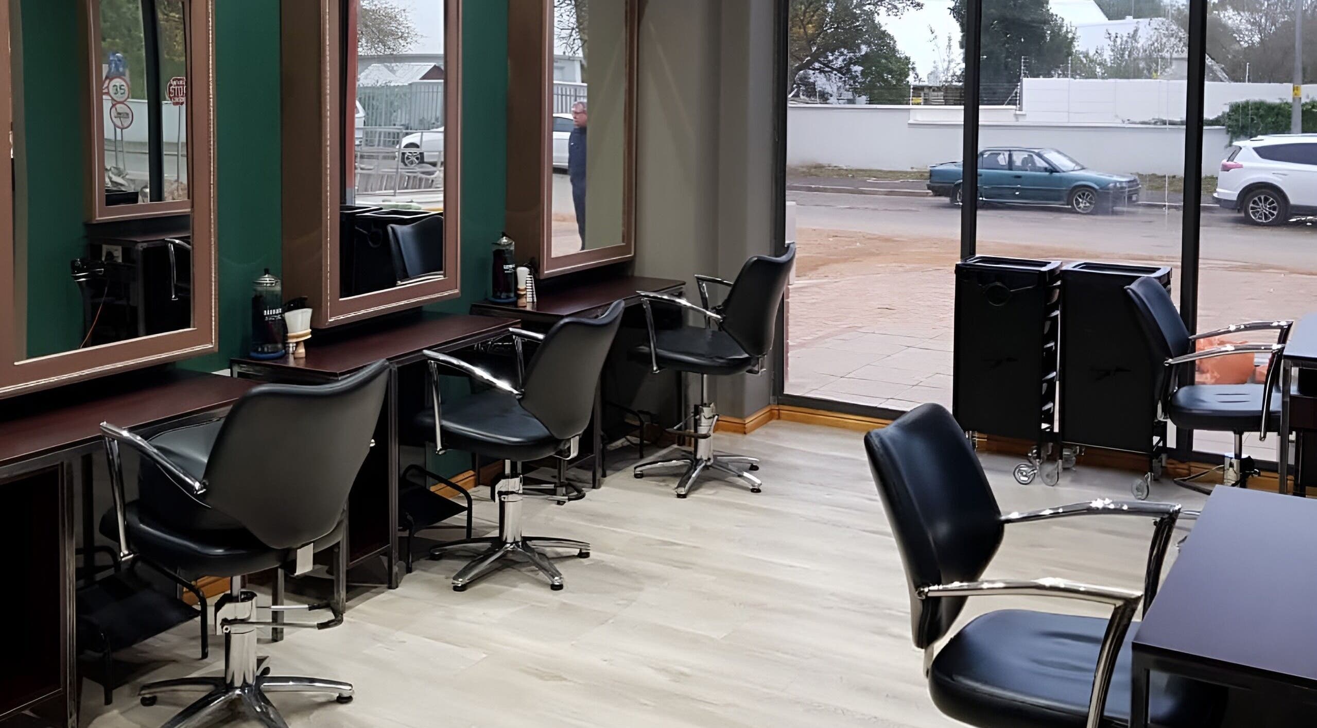 Modern salon interior at Vivi Wellness Salon, Stellenbosch, Western Cape, ZA featuring stylish black chairs.