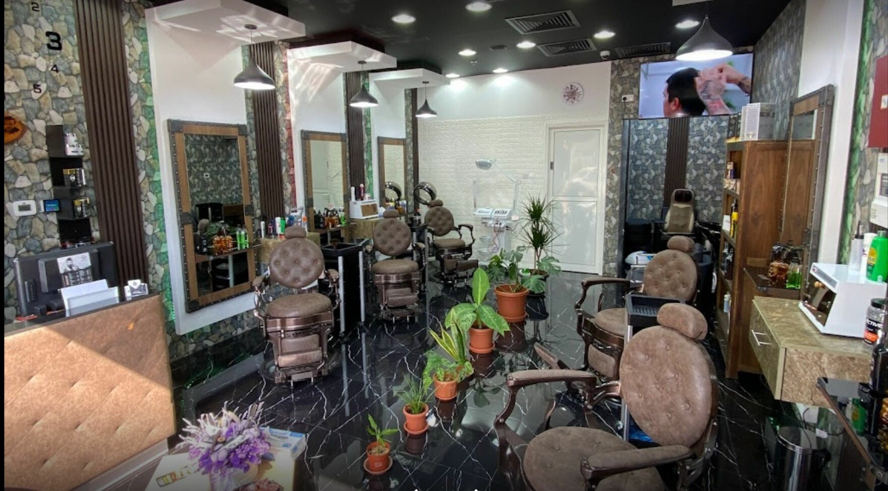 Dimassi Gents Salon interior in Dubai, AE with sleek chairs, modern decor, and plants for a relaxing atmosphere.
