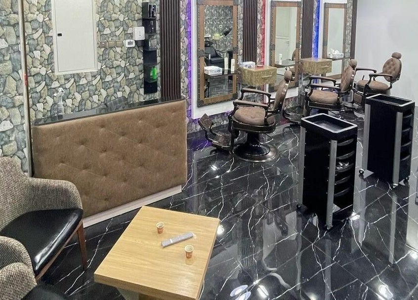 Stylish interior of Dimassi Gents Salon in Dubai, AE, featuring modern chairs and elegant decor.