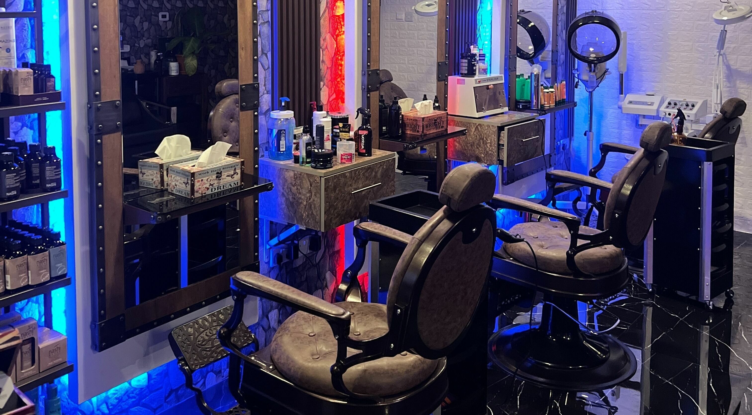 Interior of Dimassi Gents Salon in Dubai, AE, showcasing plush barber chairs and sleek grooming stations.
