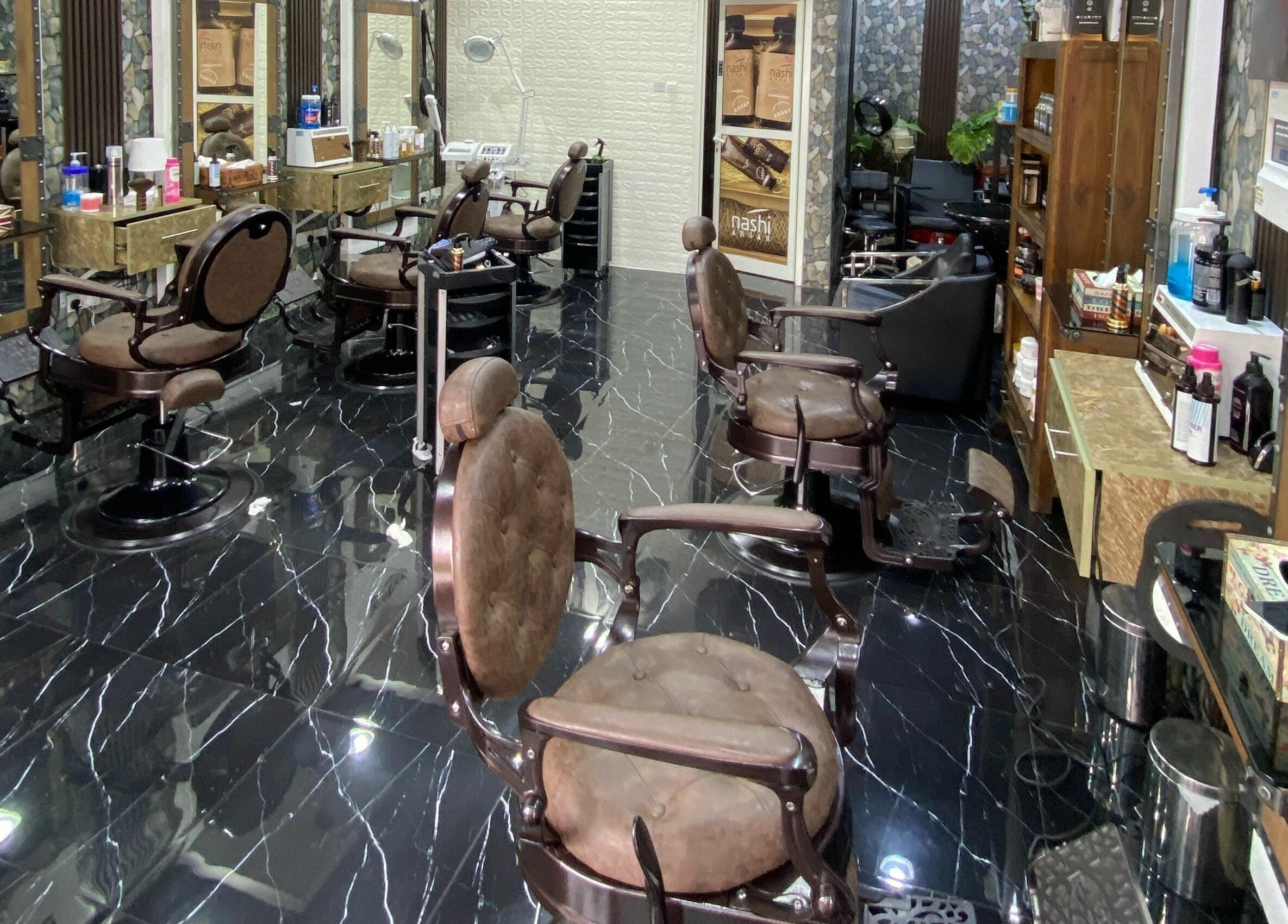 Interior of Dimassi Gents Salon in Dubai, AE, featuring stylish barber chairs and sleek decor.