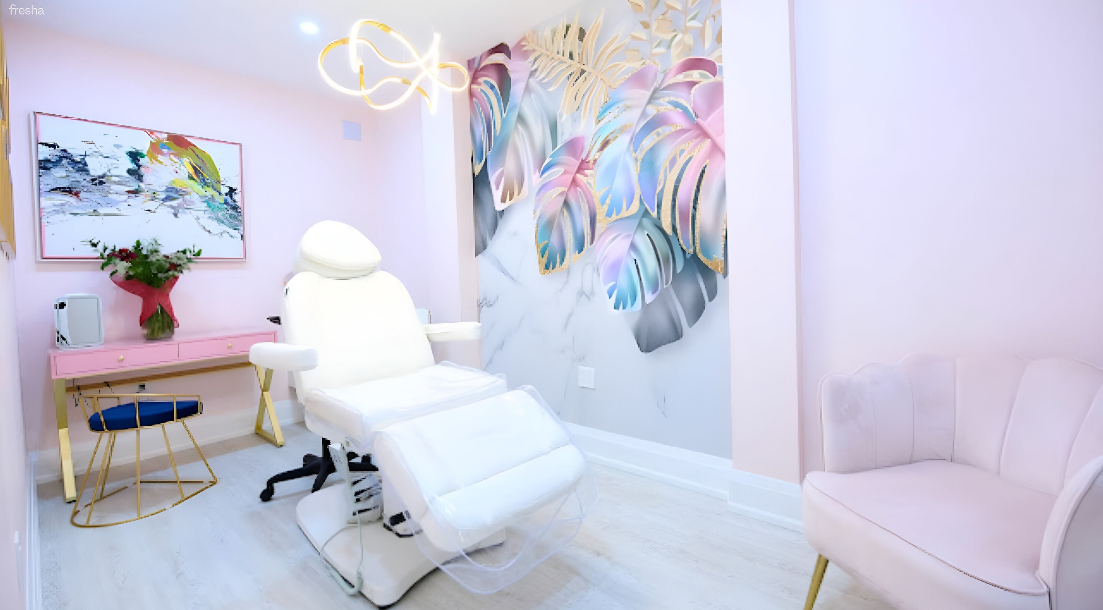 Modern treatment room at The Glam Room Beauty Clinic, Toronto, Ontario, CA with plush chairs and artistic decor.