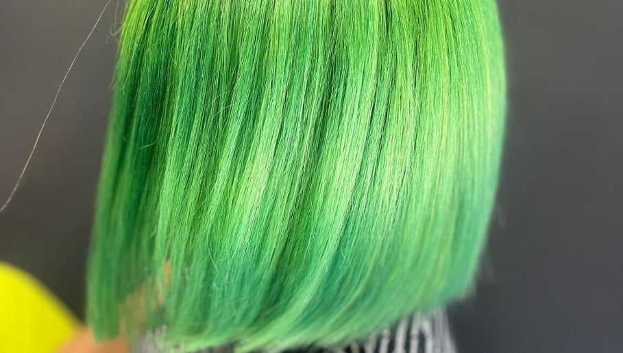 Vibrant green hair at Elite Luster by Mandie, San Antonio, Texas, US. A stunning, bold hairstyle choice.