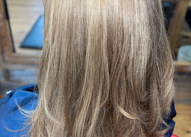 Smooth blonde layered hair styled at Elite Luster by Mandie, San Antonio, Texas, US.