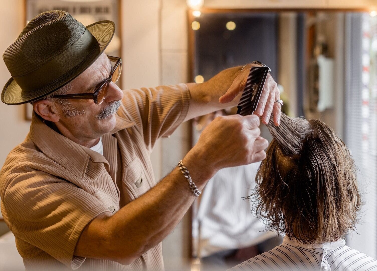 Barber styling hair at P&P Barbers — PPHH Store in Melbourne, Victoria, AU. Expert grooming services.