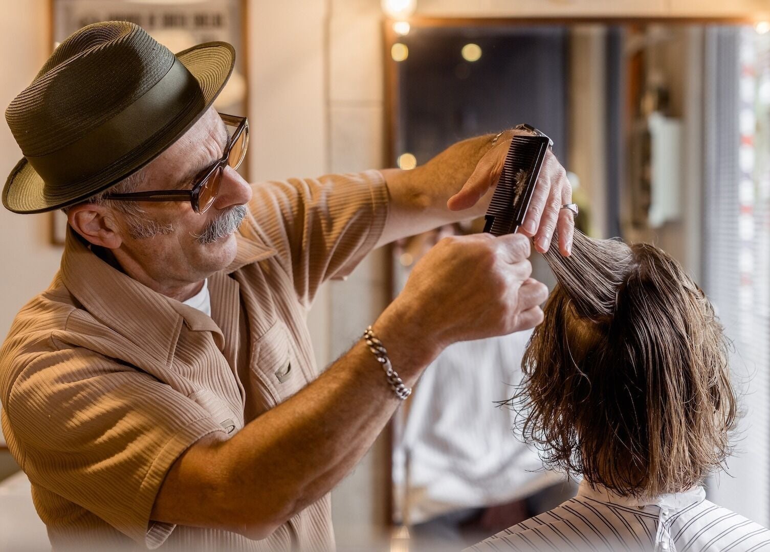 Barber styling hair at P&P Barbers — PPHH Store in Melbourne, Victoria, AU. Expert grooming services.