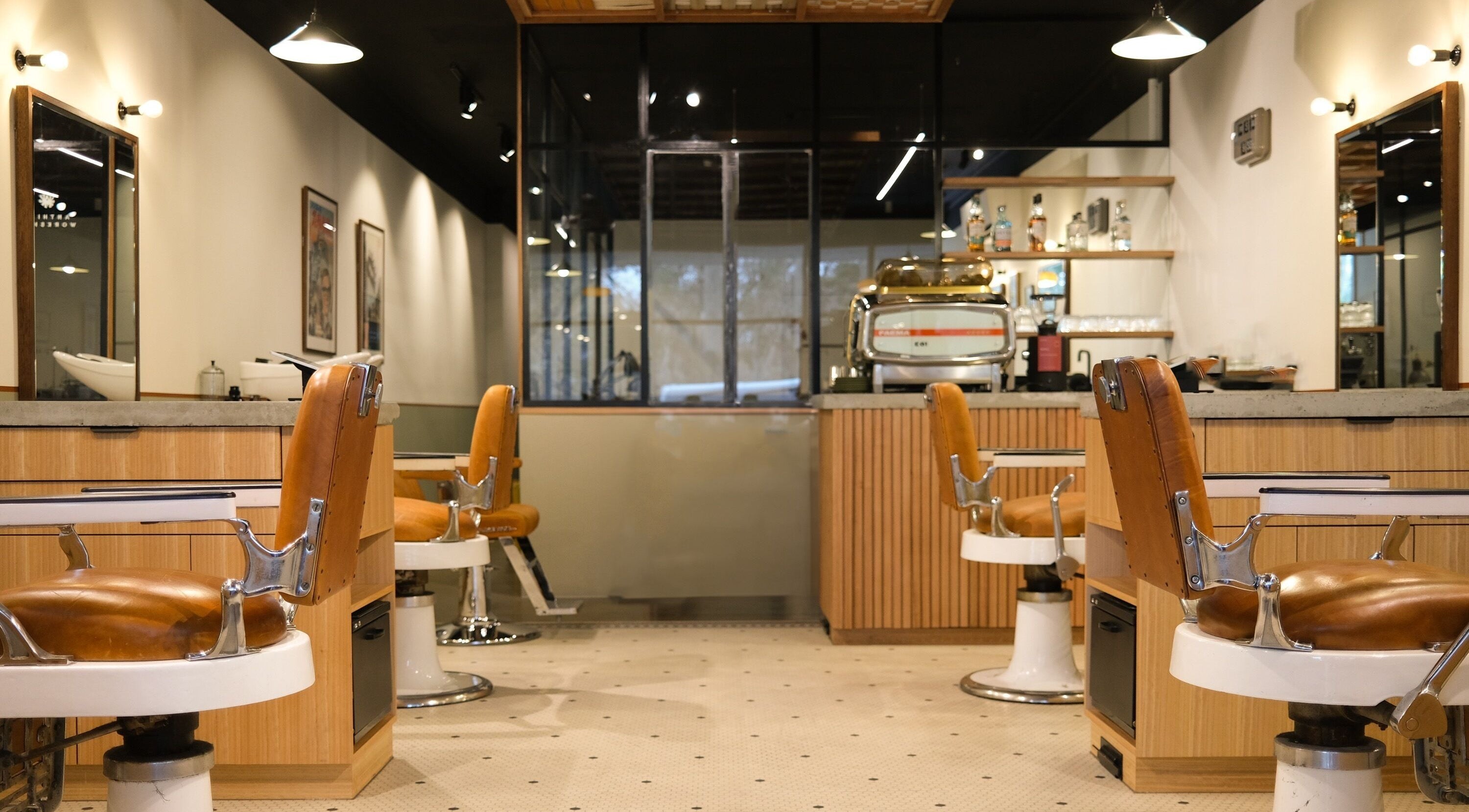 Elegant interior of P&P Barbershop in Melbourne, Victoria, AU, featuring vintage barber chairs and modern decor.