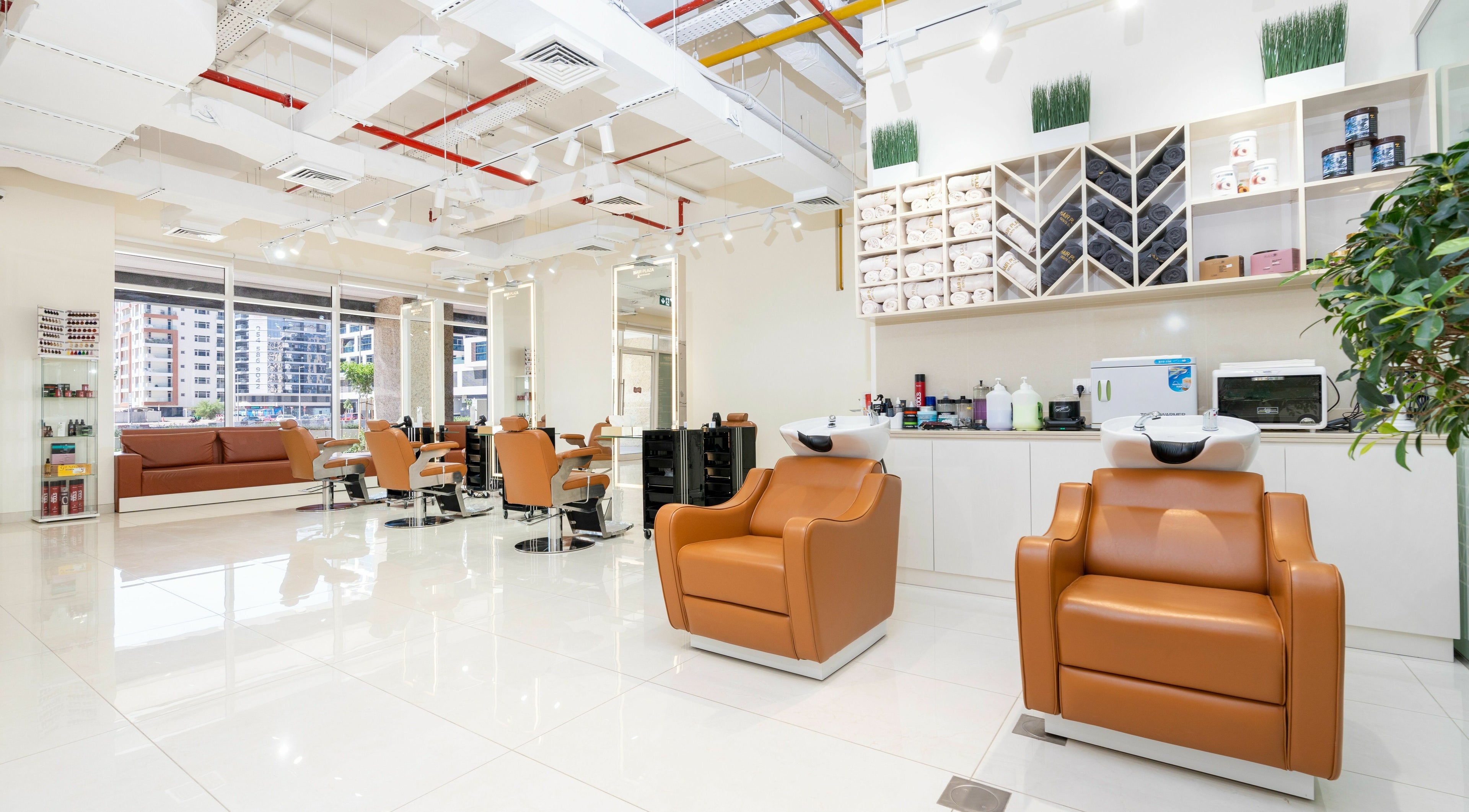 Modern interior of Hair Plaza Gents Salon in Dubai, Dubai, AE, featuring stylish seating and sleek decor.