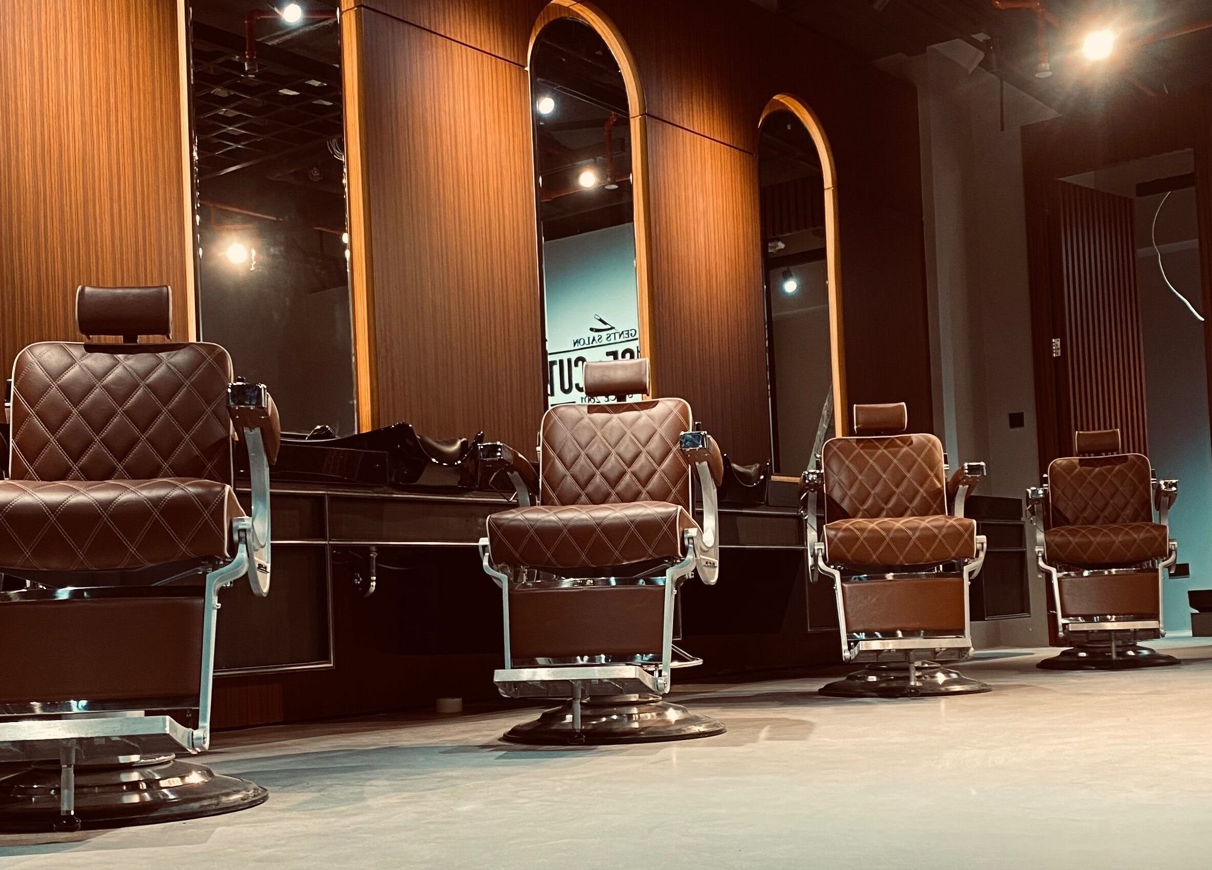 Luxurious barber chairs at House of Cuts - Media City in Dubai, Dubai, AE, offering premium grooming.