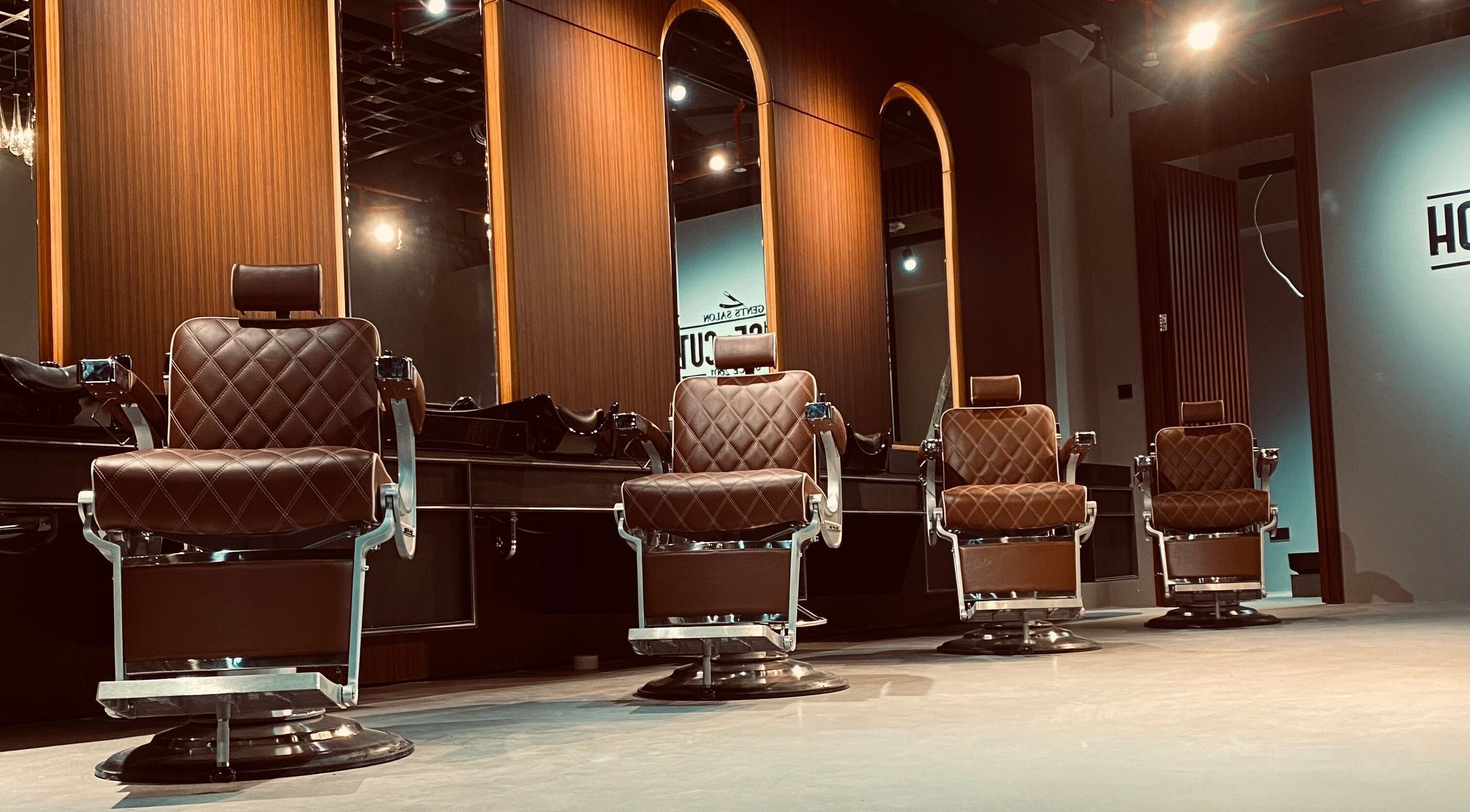 Luxurious barber chairs at House of Cuts - Media City in Dubai, Dubai, AE, offering premium grooming.