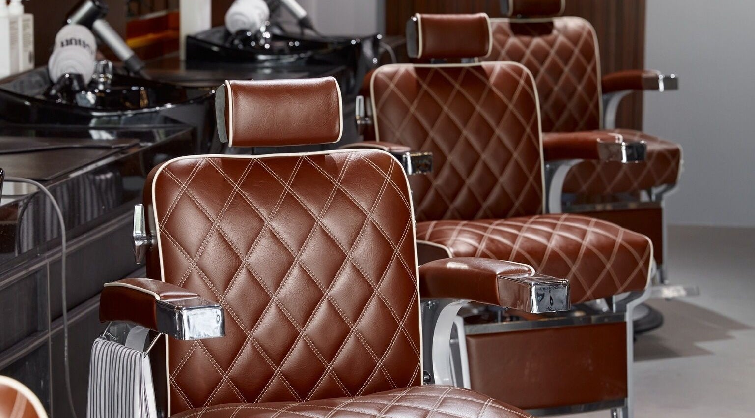 Luxurious barber chairs at House of Cuts - Media City, Dubai, Dubai, AE exuding comfort and style.