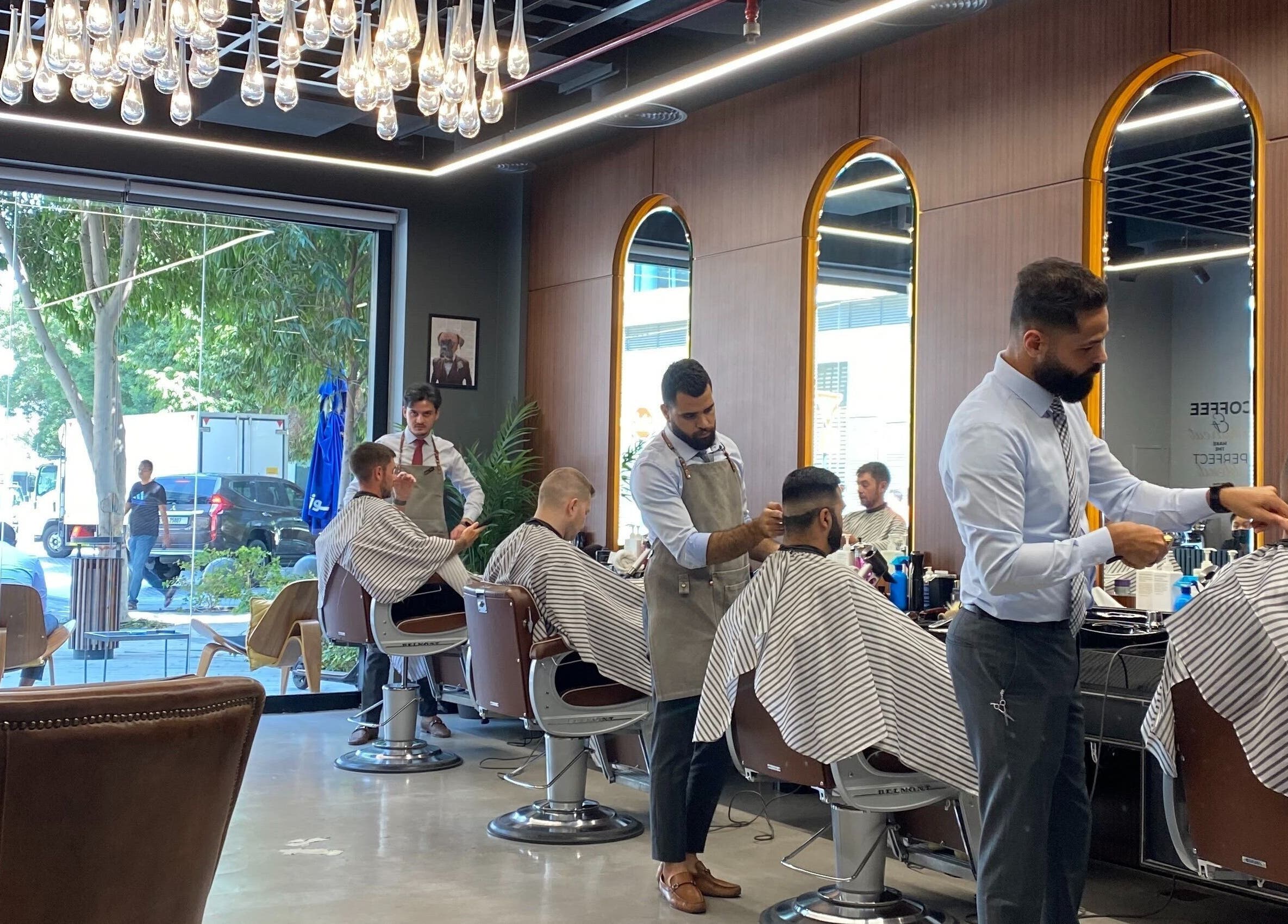 Barbers at House of Cuts - Media City in Dubai, AE offering stylish haircuts in a modern salon.