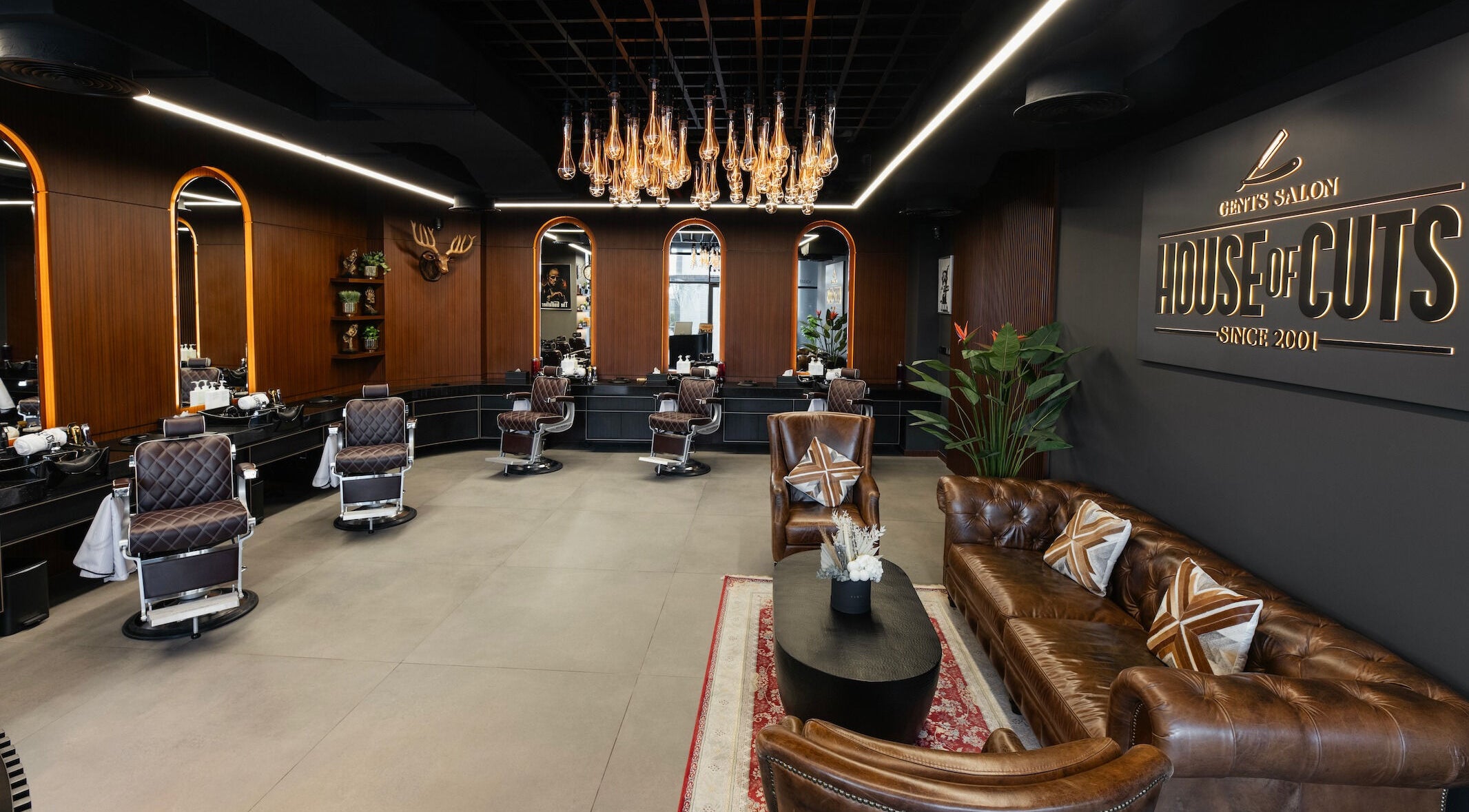 Chic interior of House of Cuts - Business Bay, Dubai, Dubai, AE featuring brown leather seating and vintage barber chairs.