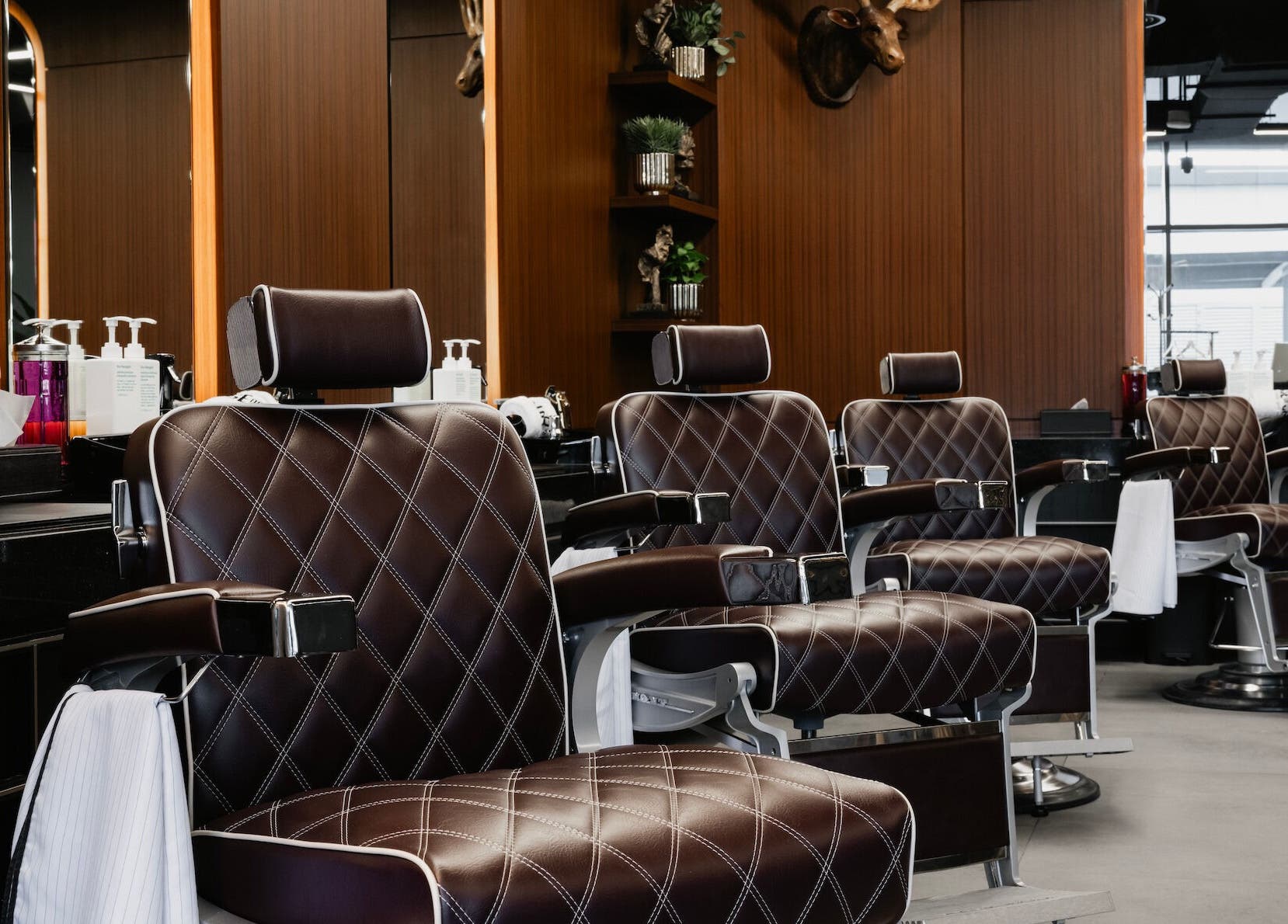 Luxurious barber chairs at House of Cuts - Business Bay, Dubai, Dubai, AE, reflecting a stylish ambiance.
