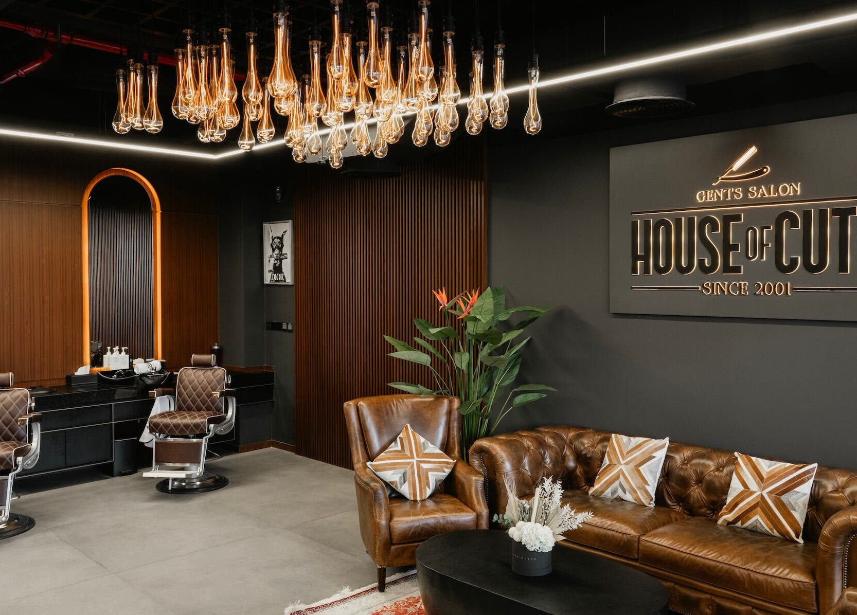 Stylish interior of House of Cuts - Business Bay, Dubai, Dubai, AE featuring leather chairs and modern decor.