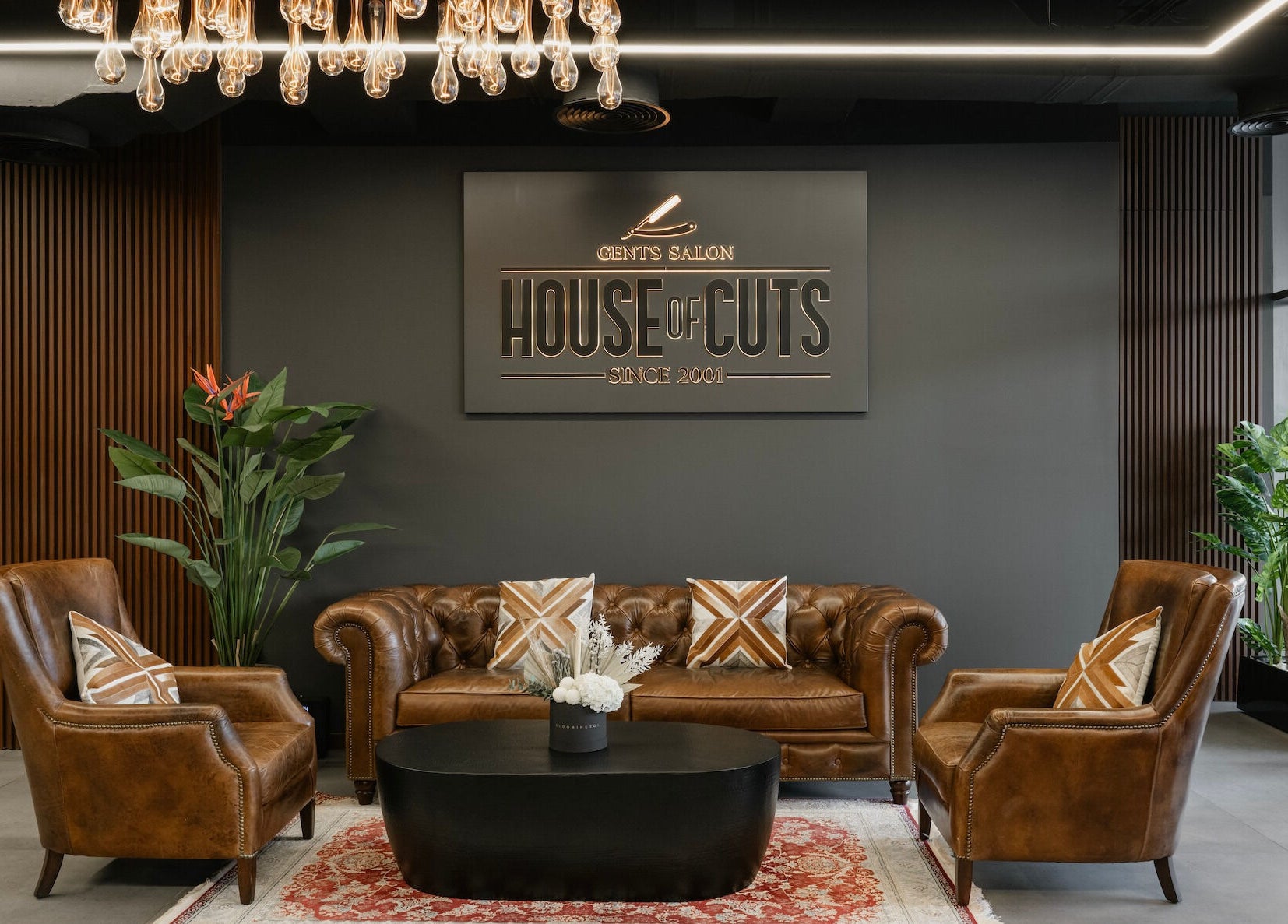 Elegant lobby at House of Cuts - Business Bay, Dubai, Dubai, AE, featuring leather seating and warm decor.