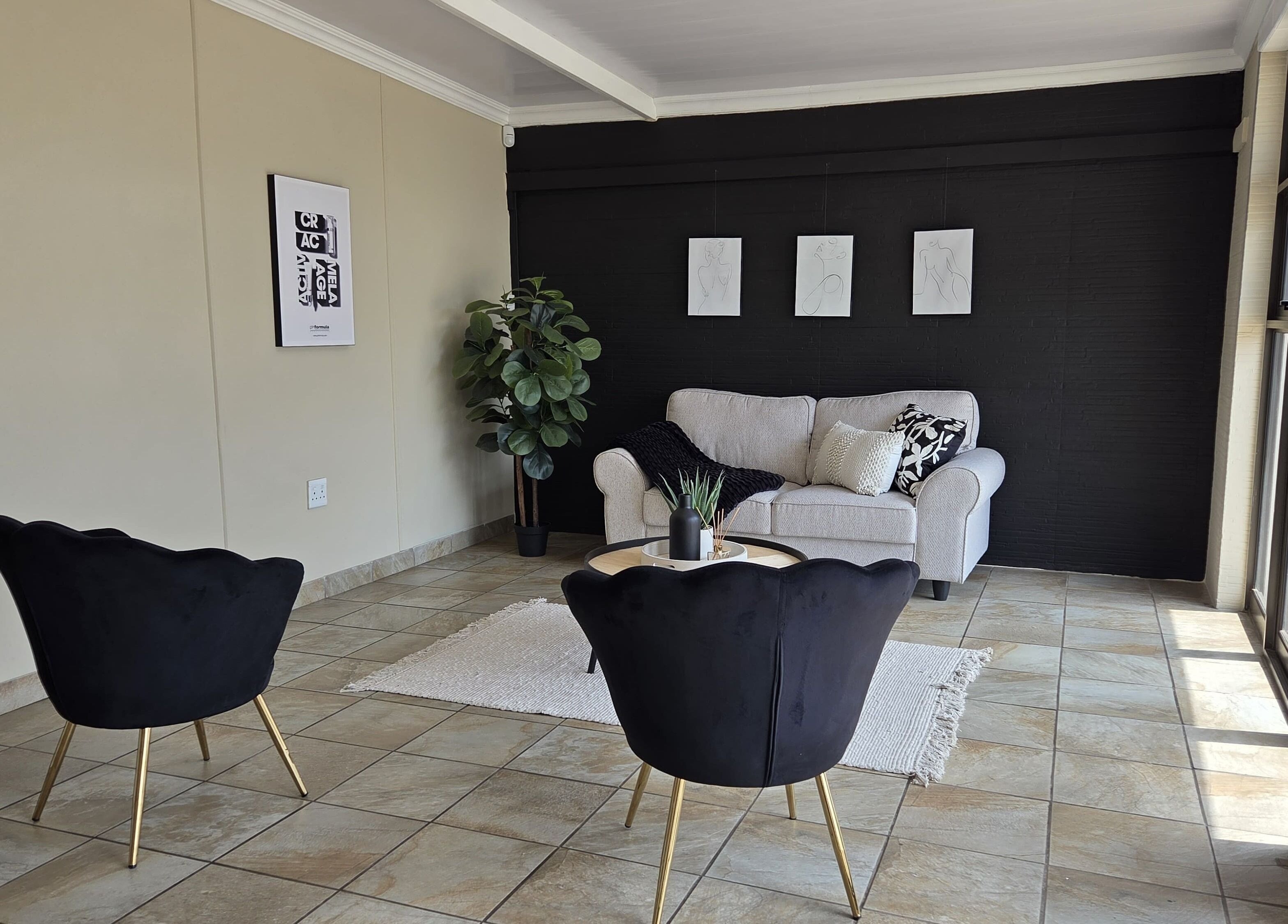 Elegant lounge with black chairs at EM Aesthetics Potchefstroom, Potchefstroom, North West, ZA.