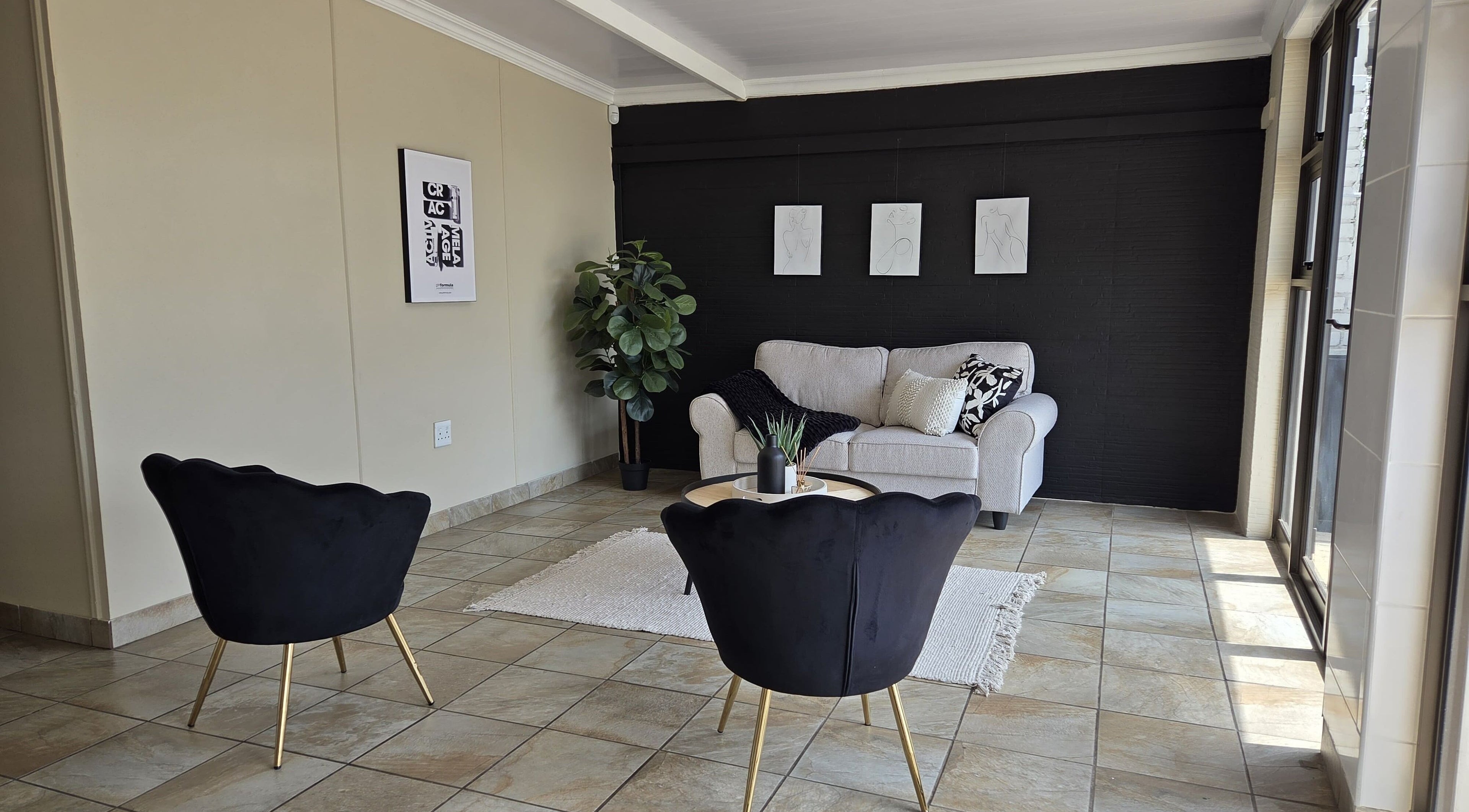 Elegant lounge with black chairs at EM Aesthetics Potchefstroom, Potchefstroom, North West, ZA.