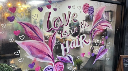 Colorful window art at Rehab Hair Salon in Allesley, Park, England, GB, with 'Love is in the Hair' motif.